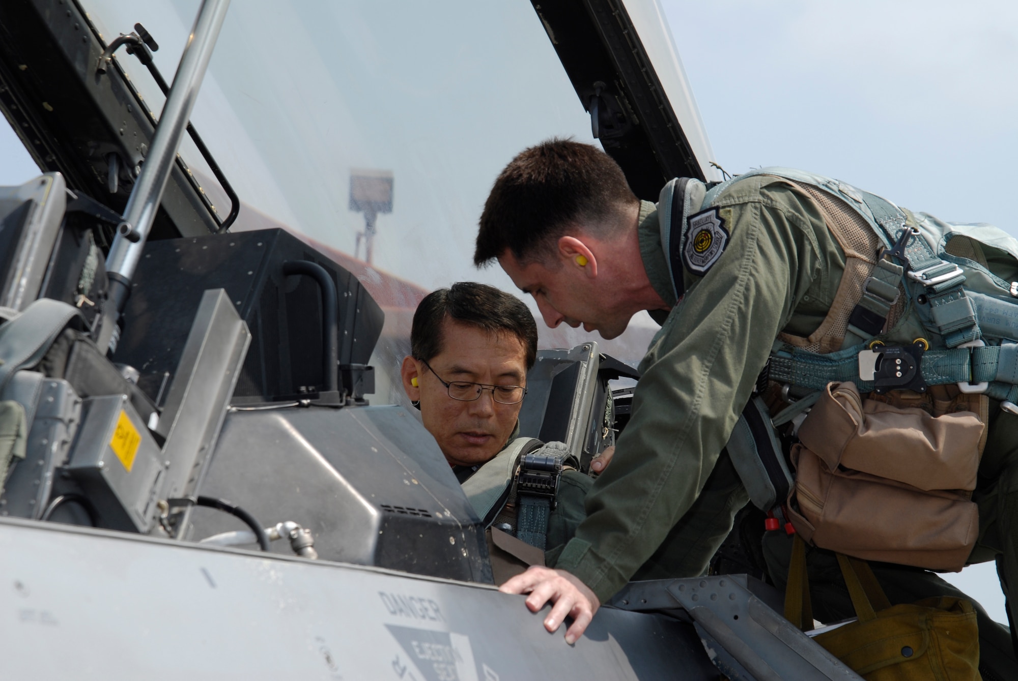 KUNSAN AIR BASE, Republic of Korea--Republic of Korea Air Force Lt. Gen. Cho Won Kun, Air Force Operations Center commander, straps into a 35th Fighter Squadron F-16 with assistance from Lt. Col. Steven "Dawg" Kennel, 35th Figher Squadron commander here Sept. 10. (U.S. Air Force photo/Staff Sgt. Jason Colbert)