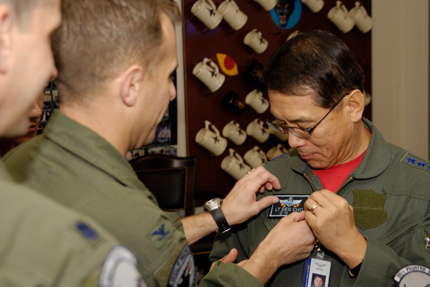 KUNSAN AIR BASE, Republic of Korea--Col. Bryan "Wolf" Bearden, 8th Fighter Wing commander, affixes Republic of Korea Air Force Lt. Gen. Cho Won Kun's name tag to his flight suit. General Cho, the Air Force Operations Center Commander, received an orientation flight here, Sept. 10. (U.S. Air Force photo/Staff Sgt. Jason Colbert)