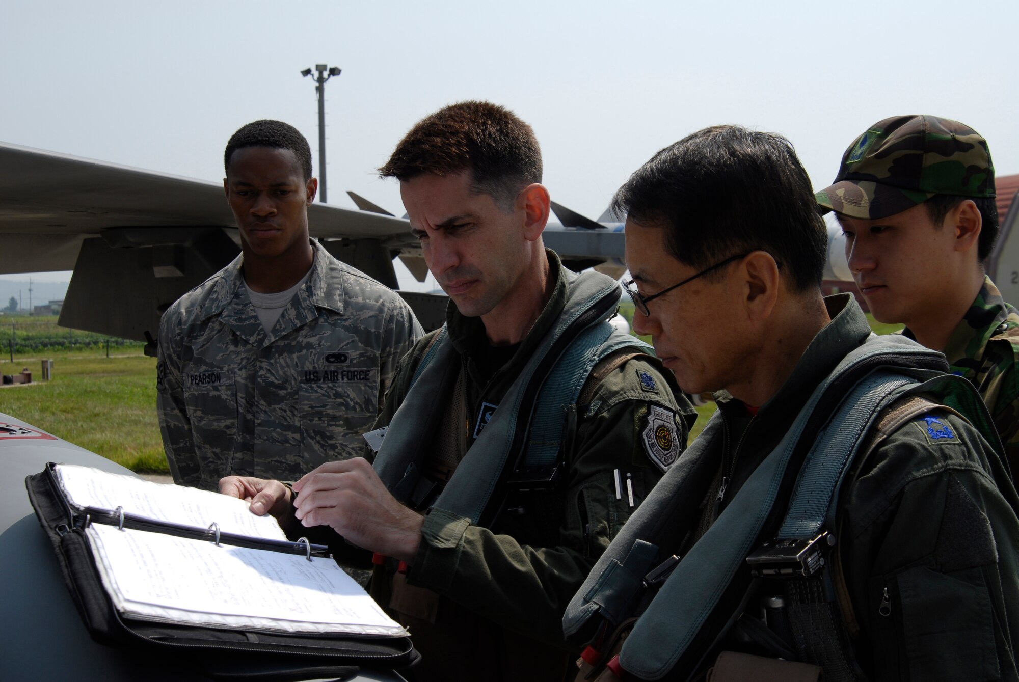 KUNSAN AIR BASE, Republic of Korea--Republic of Korea Air Force Lt. Gen. Cho Won Kun, Air Force Operations Center commander, is briefed on the flight plan by Lt. Col. Steven "Dawg" Kennel, 35th Fighter Squadron commander, before his orientation flight here Sept. 10. (US Air Force photo by Staff Sgt. Jason Colbert)