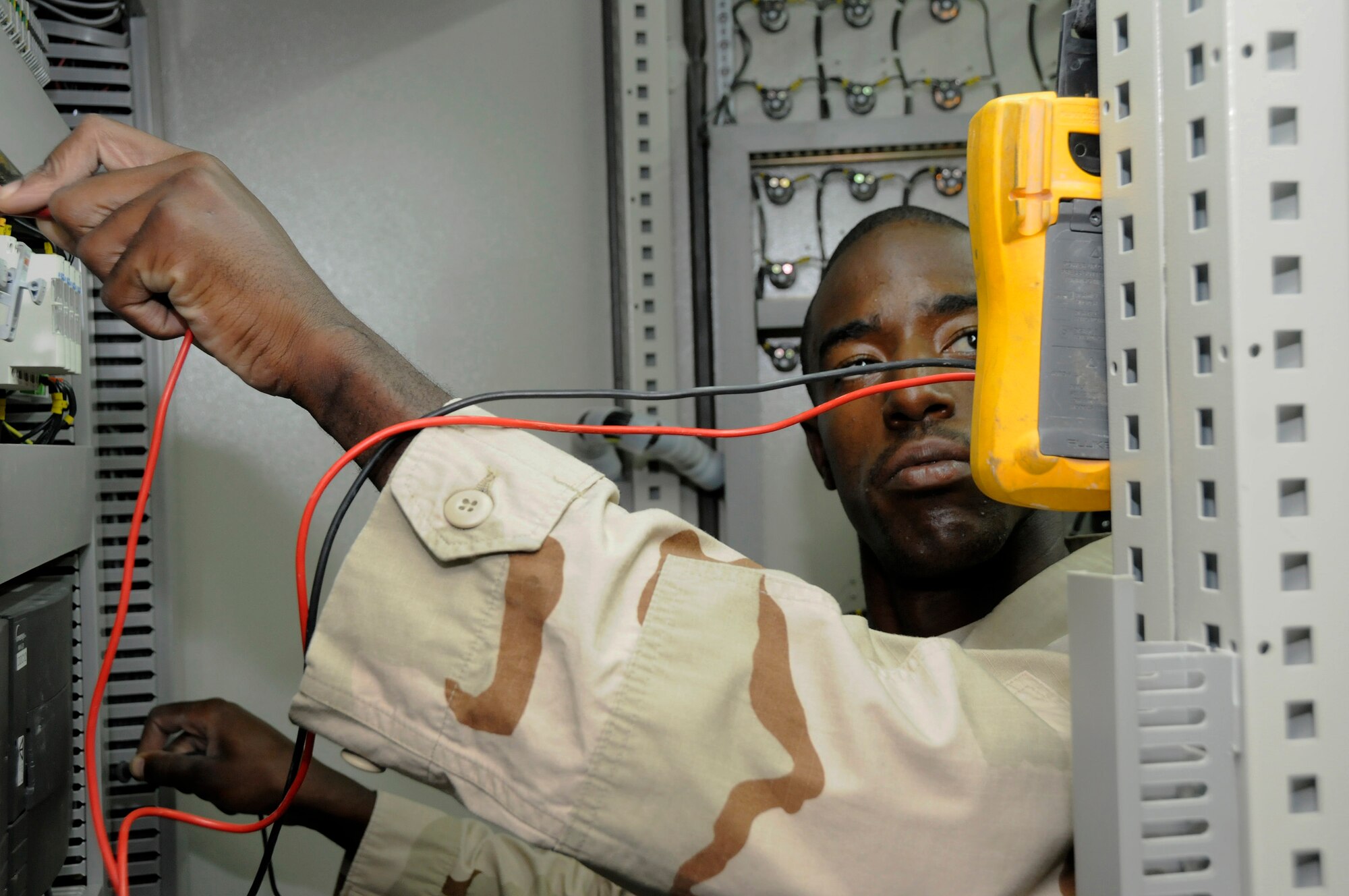 Senior Airman Lamar Reece, 379th Expeditionary Civil Engineer Squadron, checks current through a fuse, while trying to track down the source of a power blockage Sept. 11, 2008.  Airman Reece is trying to restore power to a chiller at the Base Exchange in the Blatchford-Preston Complex.  The Heating, Ventilation and Air Conditioning shop is kept busy keeping everyone else from overheating at this undisclosed location in Southwest Asia.  Airman Reece is deployed from Pope Air Force, N.C. in support of Operations Iraqi and Enduring Freedom and Joint Task Force-Horn of Africa.  (U.S. Air Force photo by Tech. Sgt. Michael Boquette/Released)