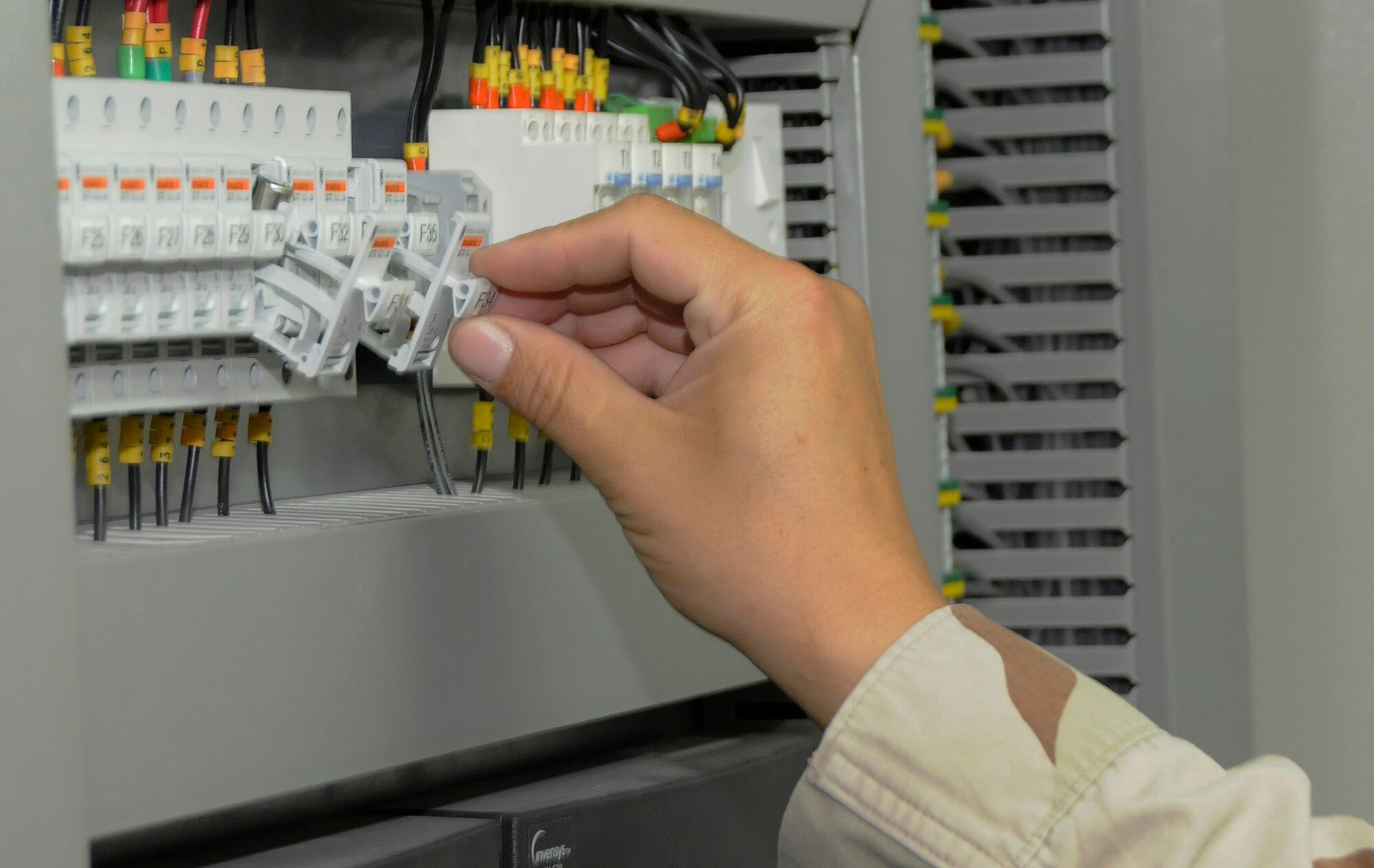 Staff Sgt. Danny Garcia, 379th Expeditionary Civil Engineer Squadron, checks two fuses on the Direct Digital Control (DDC) panel Sept. 11, 2008.   The DDC panel controls power for all Heating, Ventilation and Air Conditioning systems at the Base Exchange in the Blatchford-Preston Complex.  The HVAC shop is in charge of maintenance of all air conditioning units at this undisclosed location in Southwest Asia.  Sergeant Garcia is deployed from McChord Air Force Base, Wash., supporting Operations Iraqi and Enduring Freedom and Joint Task Force-Horn of Africa.  (U.S. Air Force photo by Tech. Sgt. Michael Boquette/Released)