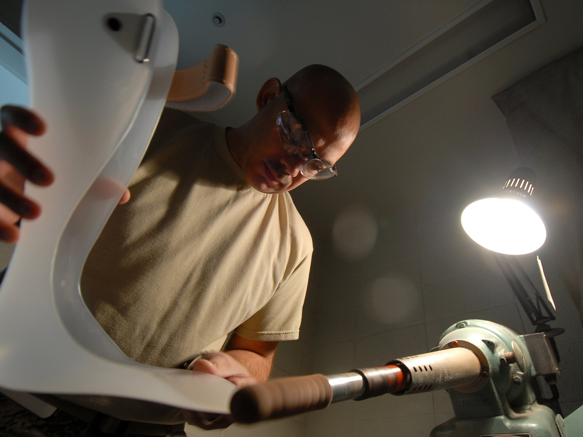 YOKOTA AIR BASE, Japan -- Technical Sergeant Sean McClintock smooths out a brace for a patentient here, in the Orthotic Lab, on 10 Septeber. This shop services not only Yokota but other local sister service bases. (U.S. Air Force photo by Senior Airman Laszlo Babocsi)(Released)