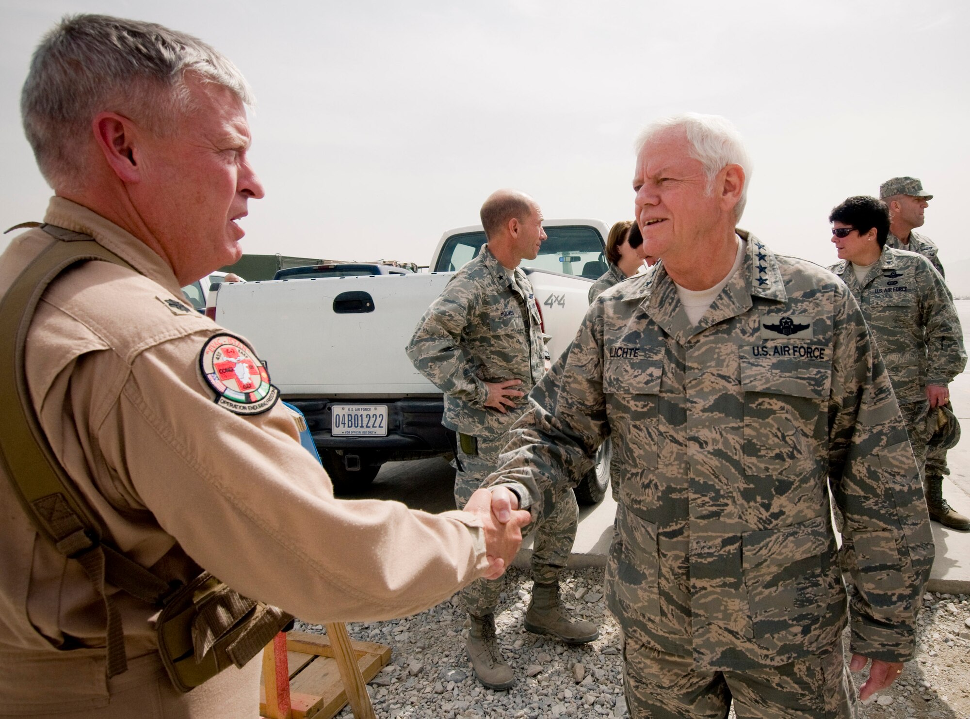 BAGRAM AIR FIELD, Afghanistan -- Gen. Arthur Lichte, Air Mobility Command commander, shakes hands with Lt. Col. Randy Miller, 455th Expeditionary Aeromedical Evacuation Flight commander, here September 10, 2008. General Lichte toured the 455th EAEF to offer words of encouragement to the Airmen there, letting them know what a difference they make in the mission at Bagram Air Field. (U.S. Air Force photo by Staff Sgt. Samuel Morse/Released)