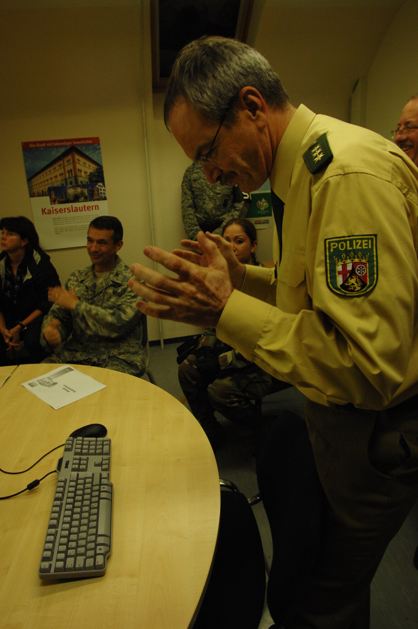 Polizeidirektor Thomas Bruhl (right) briefs the night town patrol to include Colonel Donald Bacon (left), 435th Air Base Wing commander, before going out, Sept. 5, 2008, Kaiserslautern, Germany.  The 569th United States Forces Police Squadron and local Polizei work together to keep the streets of Kaiserslautern safe.  (U.S. Air Force photo by Senior Airman Amber Bressler)(Released)