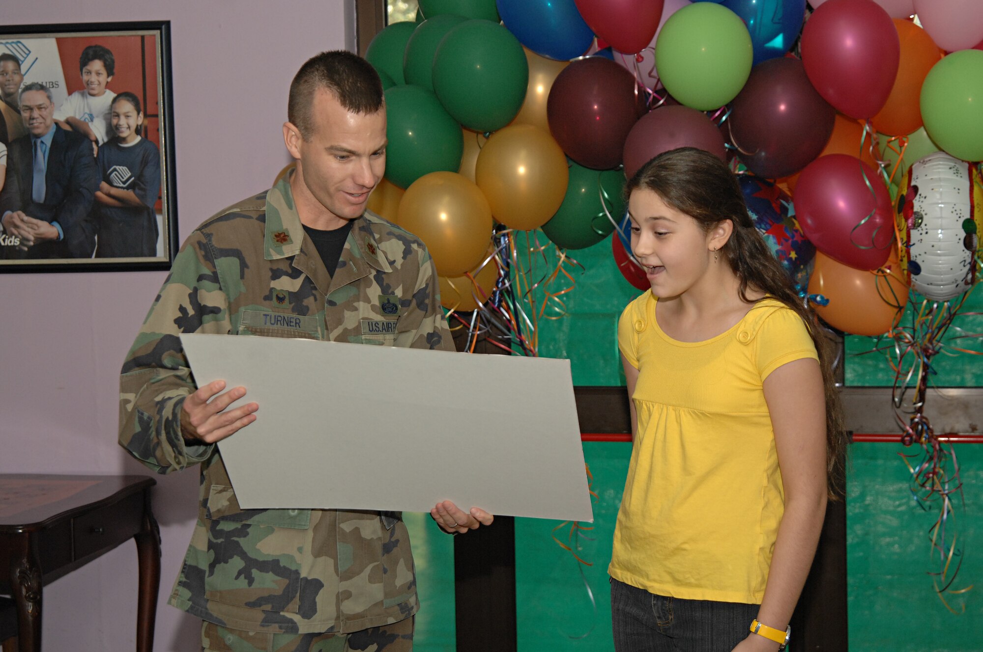 Maj. James Turner, 39th Force Support Squadron commander, presents Kati Kaya with, the grand prize, a free trip to Disney World Resort in Orlando, Florida, Sept. 5. Kaya can bring up to three family members on the trip, which includes round trip airfare, hotel accommodations and rental car. (U.S. Air Force photo by Senior Airman Benjamin Wilson)