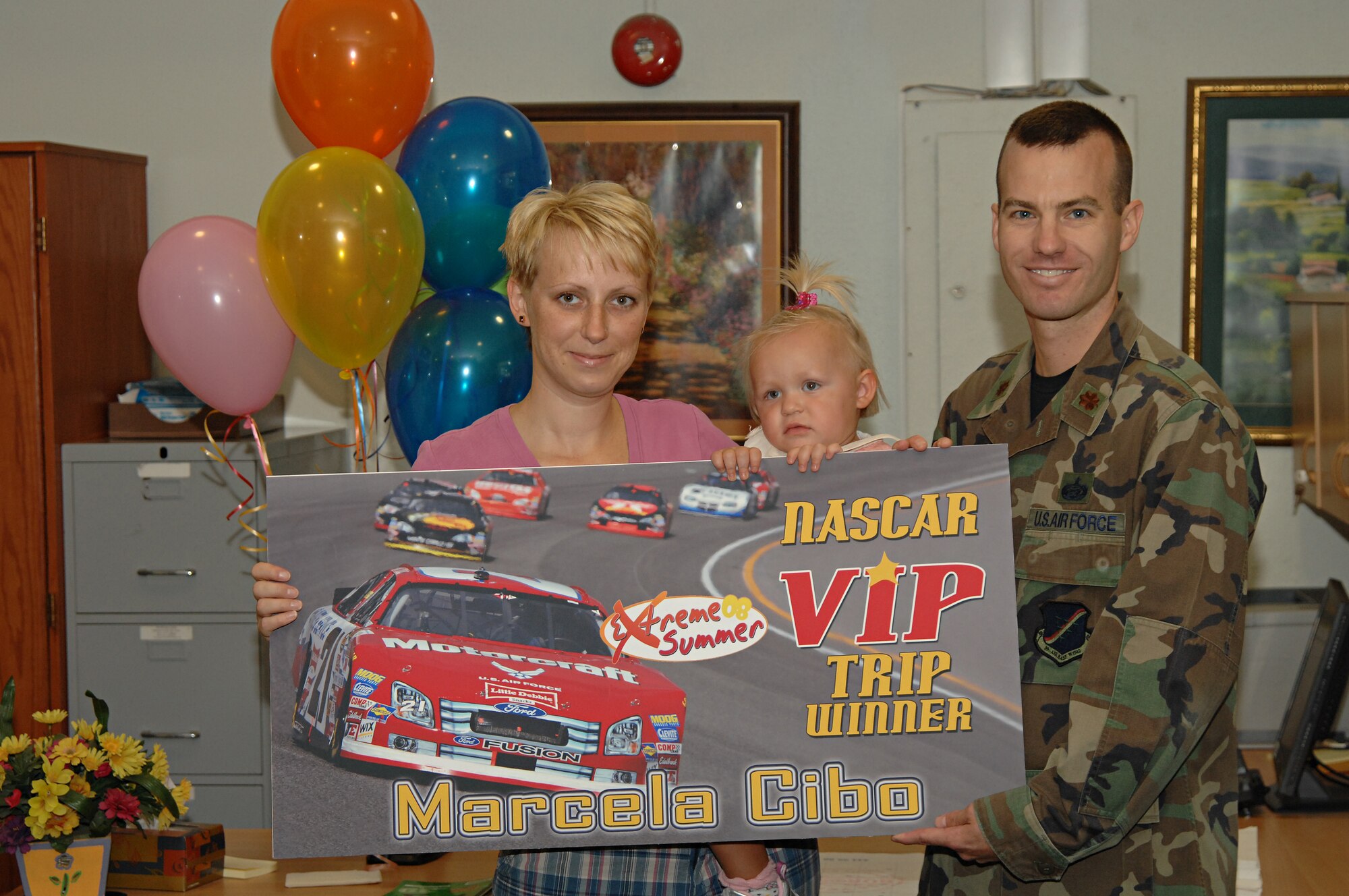 Maj. James Turner, 39th Force Support Squadron commander, presents Marcela Cibo, the grand prize, a set of two VIP gold tickets to the October 2008 NASCAR Nextel race at Atlanta Motor Speedway, Sept. 5. The prize includes round trip airfare, hotel accommodations, rental car and tickets to the race. (U.S. Air Force photo by Senior Airman Benjamin Wilson)