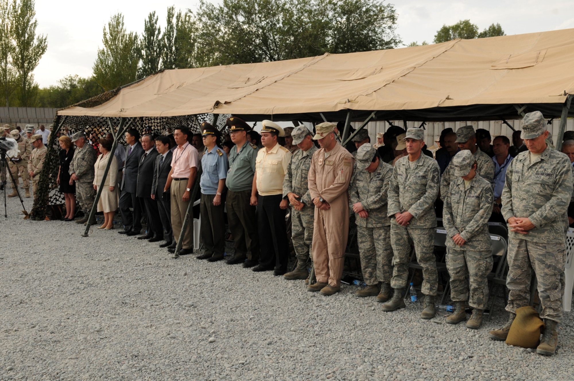MANAS AIR BASE, KYRGYZ REPUBLIC -- Dignitaries and representatives from ten nations pay their respects with more than 200 coalition servicemembers during the Sept. 11 remembrance ceremony here. The event paid tribute to the tragic events of 9/11 and the sacrifices made in the Global War on Terrorism since. (Air Force photo / Senior Airman Ruth Holcomb)  