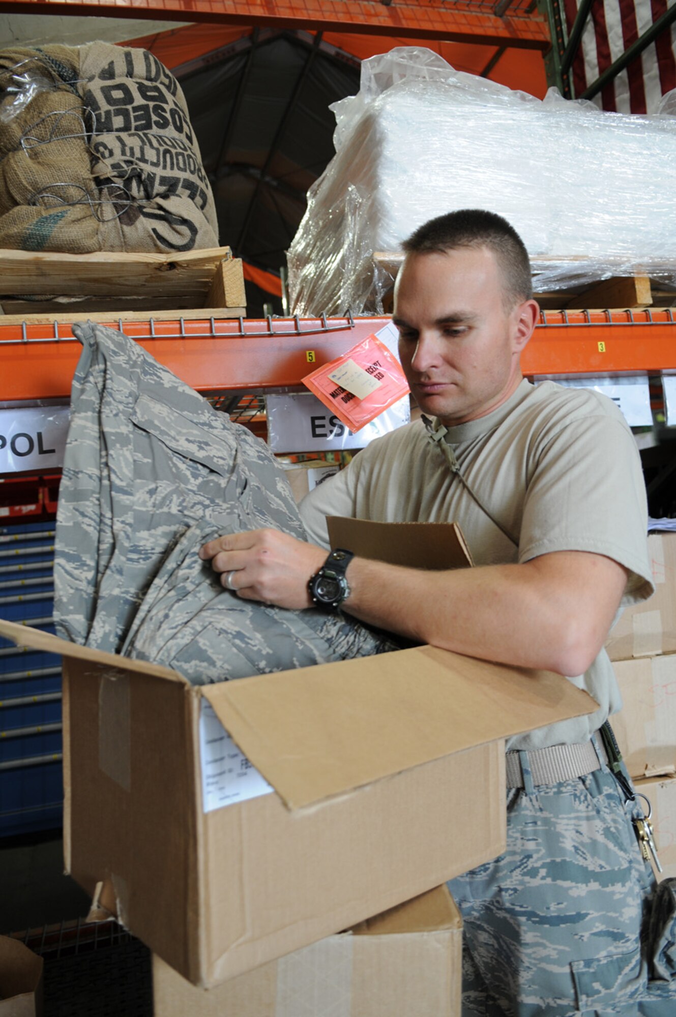 09/03/2008 - MANAS AIR BASE, KYRGYZ REPUBLIC --  Tech. Sgt. Christopher Hurst, 376th Expeditionary Security Forces Squadron, receives a box of ABU pants from 376th Expeditionary Logistics Readiness Squadron supply flight here, Sept. 3. The flight is working hard to provide Manas Airmen with the new uniform by the Air Forces Central deadline of Oct. 1. (Air Force photo / Senior Airman Ruth Holcomb)