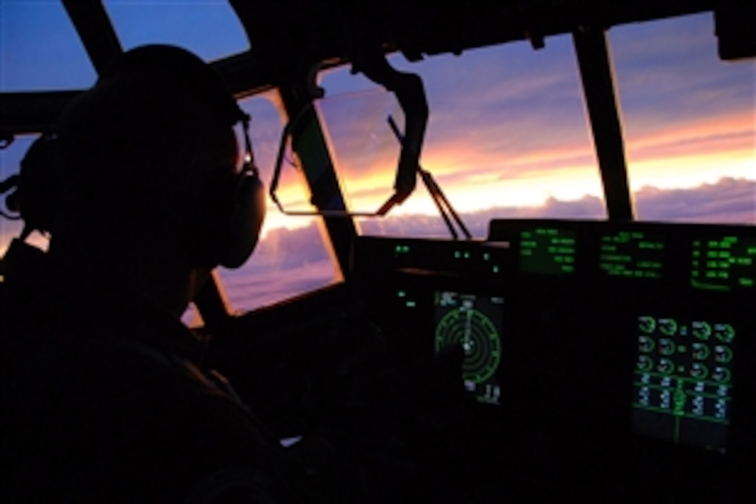Lt. Col. Mark Carter looks at the sunset after flying nine hours on a Hurricane Ike mission on board a WC-130J Hercules, Sept. 10, 2008, over the Gulf of Mexico. The Air Force Reserve Hurricane Hunters of the 403rd Wing at Keesler Air Force Base, Miss., fly 24-hours-a-day, collecting data inside the heart of Hurricane Ike. The data collected by the Hurricane Hunters improve the National Hurricane Center forecast by 30 percent. Carter is a pilot with the 403rd Wing.