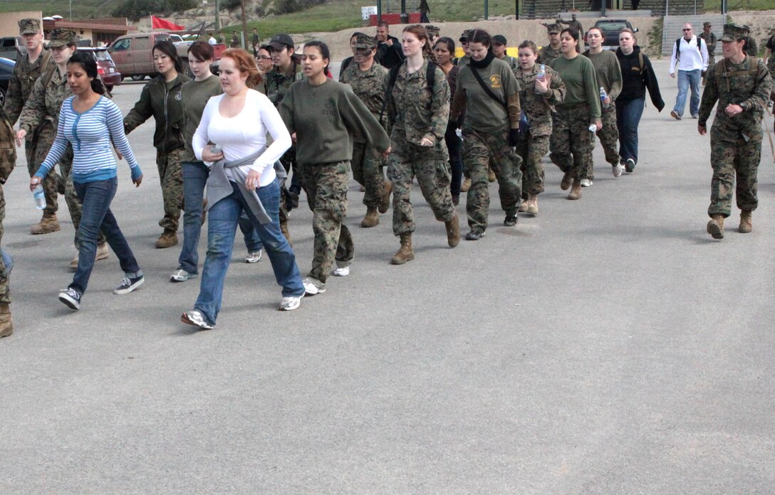 Marine spouses from Headquarters and Support Battalion, Marine Corps Base Camp Pendleton, march in formation during the battalion's annual Jane Wayne Day, March 13. The spouses had the full “Marine experience” by learning some techniques from the Marine Corps Martial Arts Program, climbing the rope of the obstacle course, firing numerous weapon systems, participating in the combat fitness test and several other activities.
