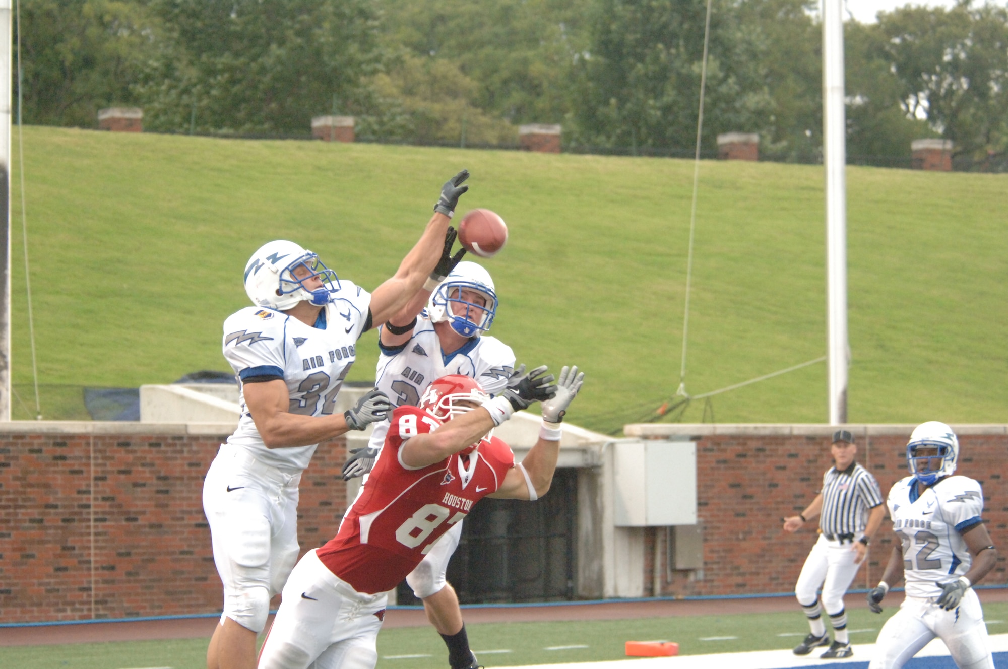 U.S. Air Force Academy linebacker Hunter Altman and safety Luke Yeager combine to bat a pass away from Houston wide receiver Mark Hafner to help stifle a Houston comeback Sept. 13 in Dallas. Despite allowing 534 yards of offense, the Falcons managed to squeak out a 31-28 win and advance to 3-0 for the season. (U.S. Air Force photo/John Van Winkle) 
