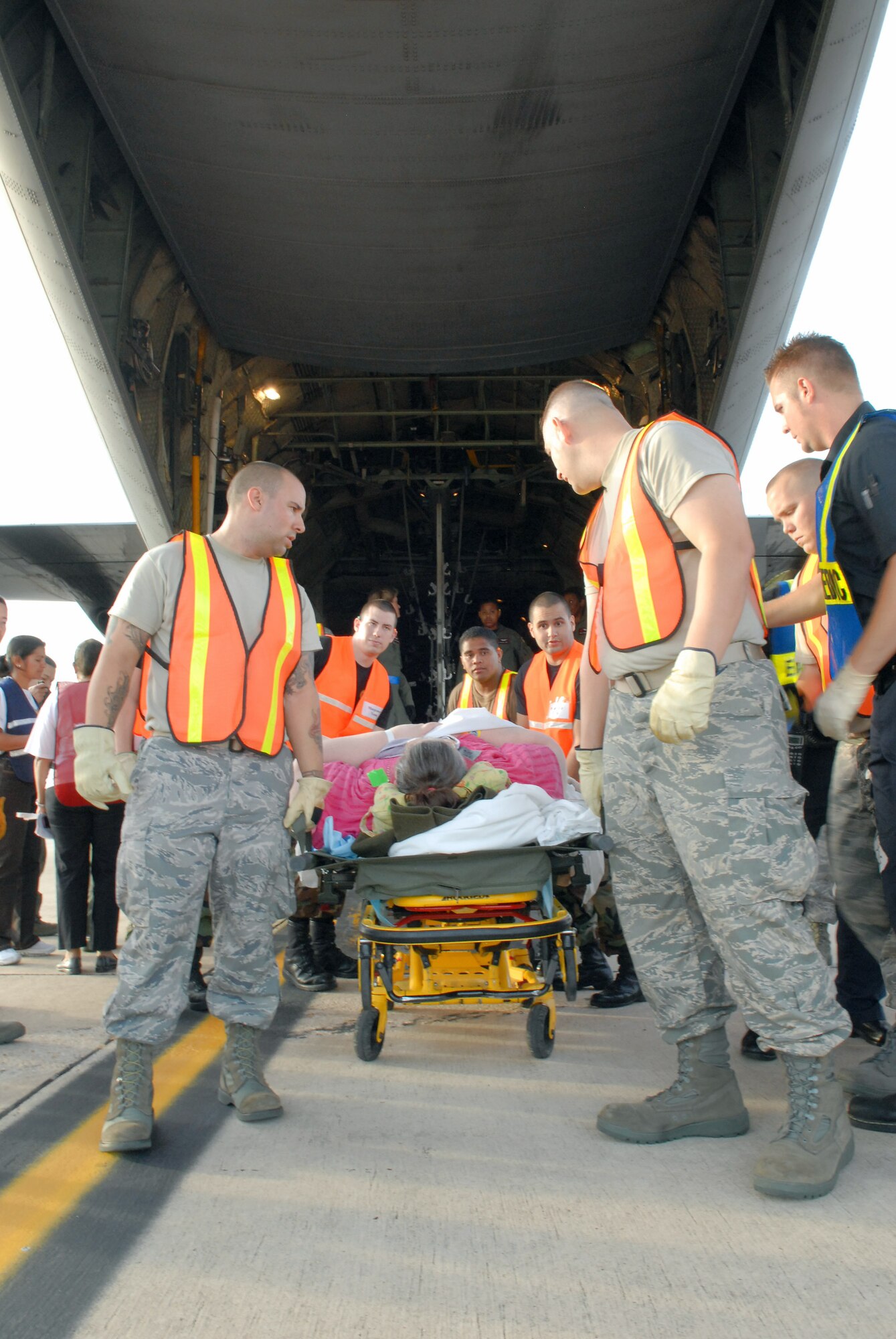 Airmen from the 37th Training Wing and 59th Medical Wing at Lackland Air Force Base in San Antonio unload hospital patients Sept. 12 evacuated from Beaumont, Texas.  The patients were transported in C-130 Hercules aircraft by aircrews from Little Rock AFB and medical Airmen from the 908th Aeromedical Evacuation Squadron at Scott AFB, Ill., in preparation for Hurricane Ike's landfall in southern Texas.  (U.S. Air Force photo/Staff Sgt. Chris Willis)