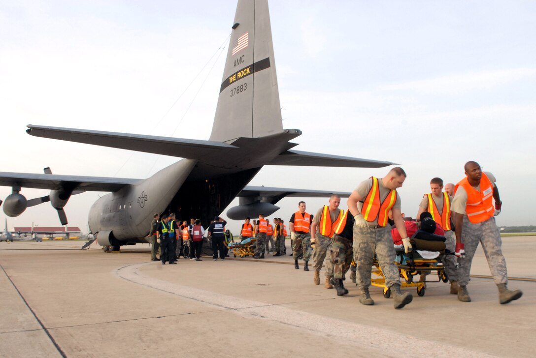 Airmen from the 37th Training Wing and 59th Medical Wing at Lackland Air Force Base in San Antonio unload hospital patients Sept. 12 evacuated from Beaumont, Texas.  The patients were transported in C-130 Hercules aircraft by aircrews from Little Rock AFB and medical Airmen from the 908th Aeromedical Evacuation Squadron at Scott AFB, Ill., in preparation for Hurricane Ike's landfall in southern Texas.  (U.S. Air Force photo/Staff Sgt. Chris Willis)