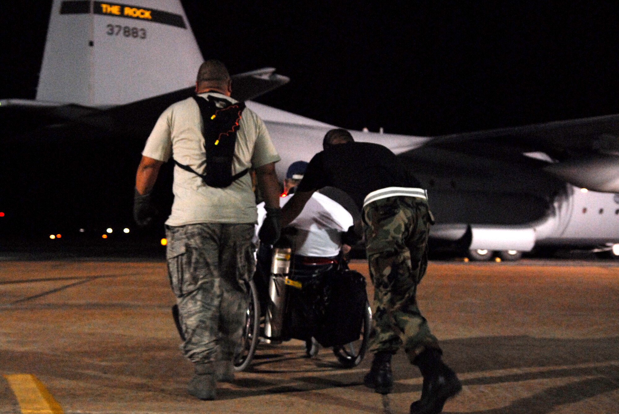 Airmen load hospital patients onto a C-130 aircraft Sept. 12 at the airport in Beaumont, Texas, for a flight to Lackland Air Force Base in San Antonio.  These patients are being transported by aircrews from Little Rock AFB, Ark., and medical Airmen from the 908th Aeromedical Evacuation Squadron at Scott AFB, Ill., in preparation for Hurricane Ike's landfall in southern Texas (U.S. Air Force photo/Staff Sgt. Chirs Willis)  
