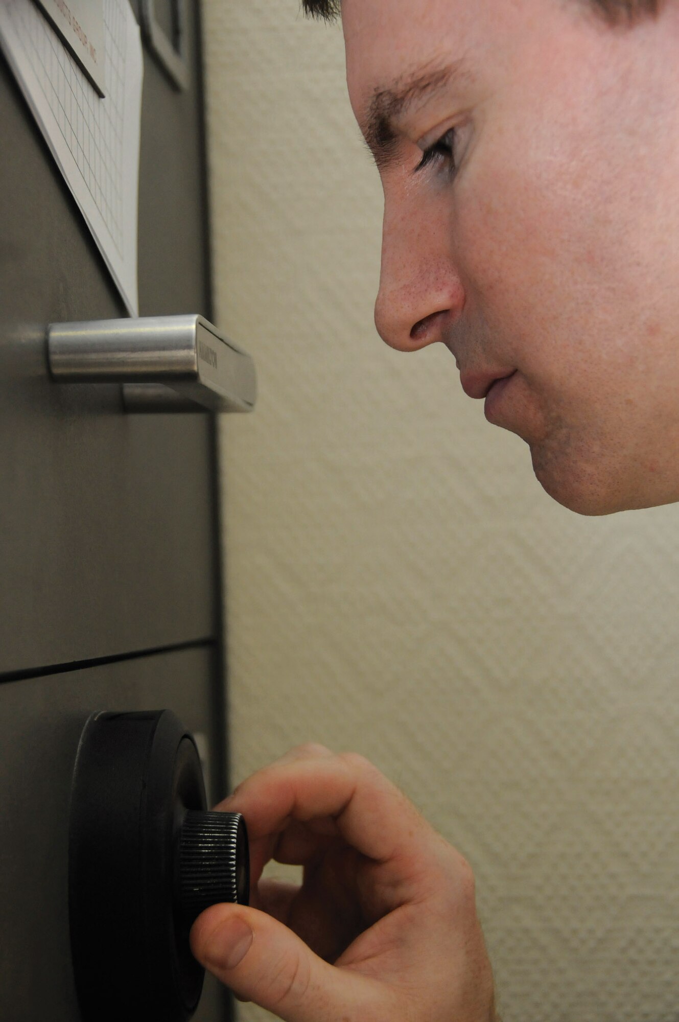 Tech. Sgt. Ray Quenneville opens a safe in Southwest Asia Sept. 8. As paying agent, he must account for all the money being deposited or cashed out to customers, which can include large sums of currency. Sergeant Quenneville is a paying agent for the 379th Expeditionary Comptroller Squadron. (U.S. Air Force photo/Staff Sgt. Darnell T. Cannady)