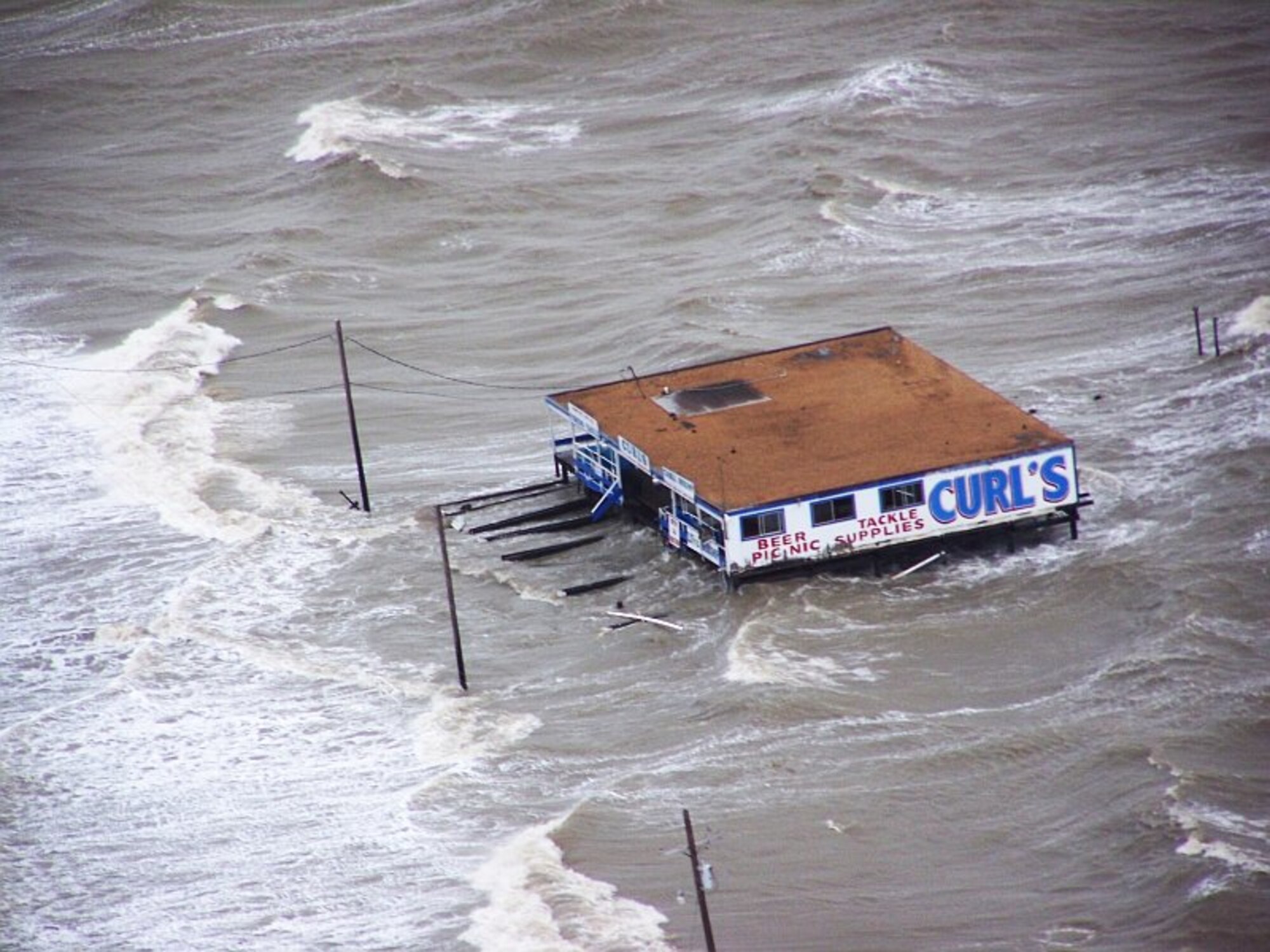Joint Task Force 129 crew, Jolly 92, flies over the storm surge that overtook the Bolivar Peninsula bridge near Galveston, Texas, Sept. 12. The California Air National Guard crew of Jolly 92 rescued six civilians and pets stranded in Galveston. (U.S. Air Force photo by Master Sgt. Wally Bacio)