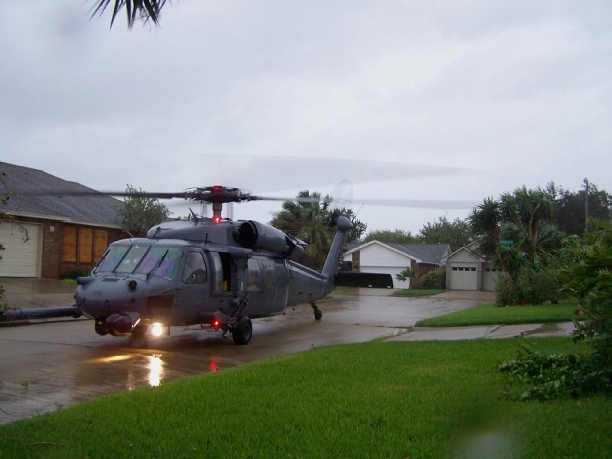 Joint Task Force 129 crew, Jolly 92, lands in a tight space between houses to rescue an adult male in Galveston, Texas, Sept. 12. The California Air National Guard crew of Jolly 92 rescued six civilians and pets stranded in Galveston. (U.S. Air Force photo by Master Sgt. Wally Bacio)