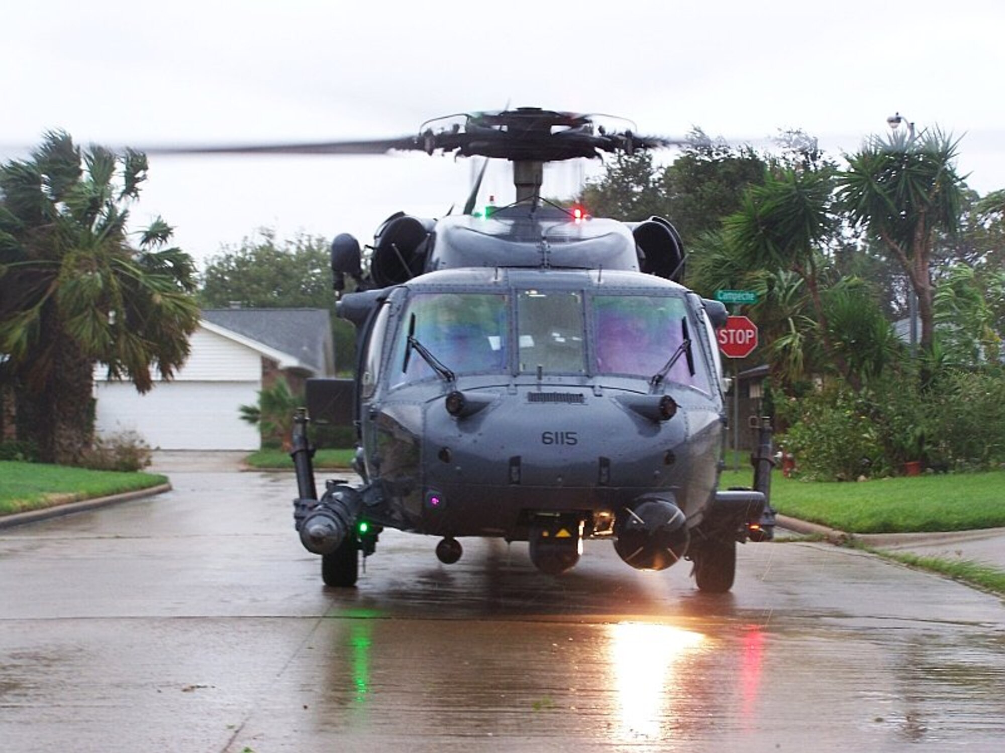 Joint Task Force 129 crew, Jolly 92, lands in a tight space between houses to rescue an adult male in Galveston, Texas, Sept. 12. The California Air National Guard crew of Jolly 92 rescued six civilians and pets stranded in Galveston. (U.S. Air Force photo by Master Sgt. Wally Bacio)