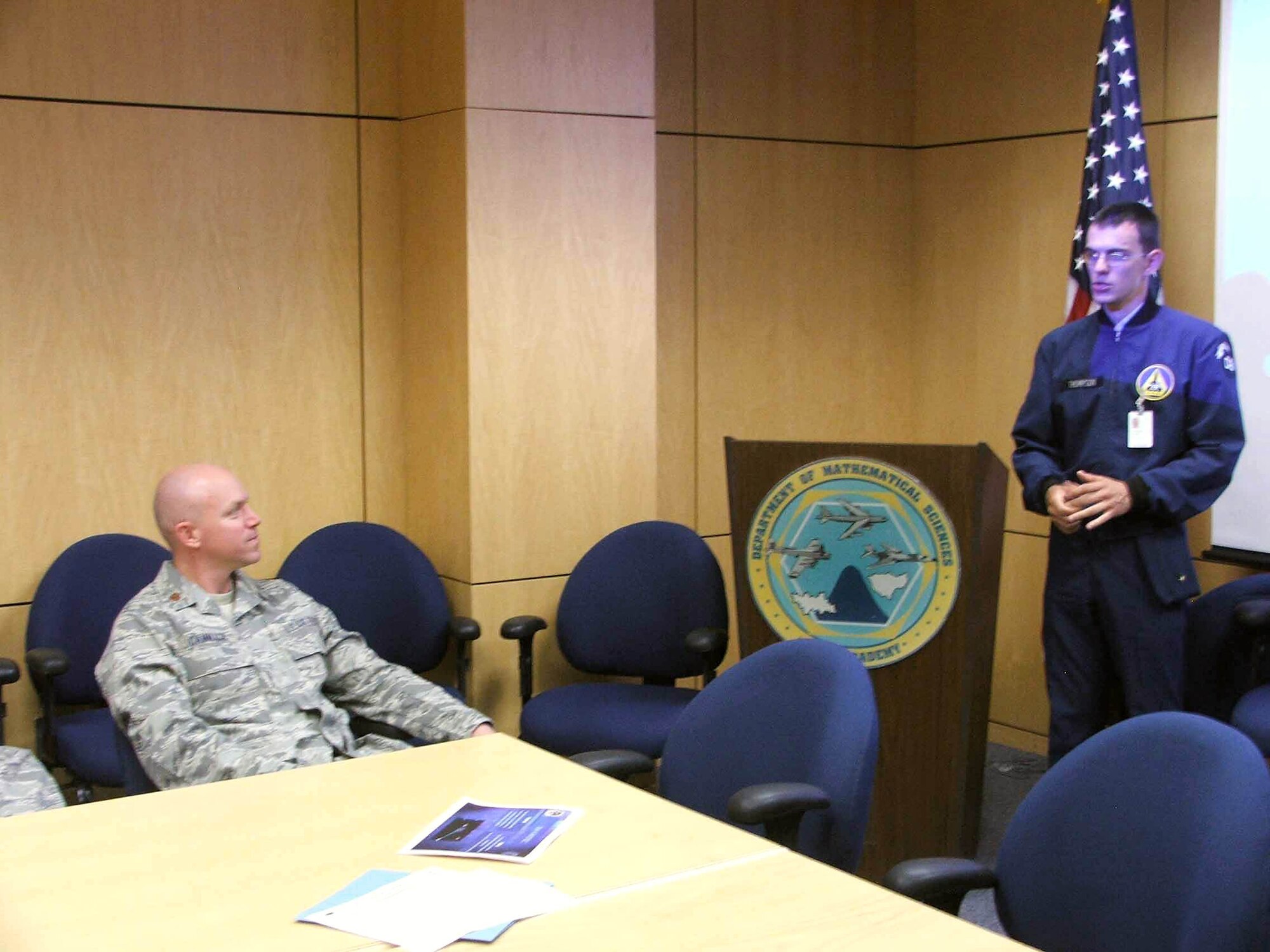 Air Force Academy Cadet First Class Jeremy Thompson briefs Maj. Dan Cammack on the outcome of his wideband global satcom reliability study.  Cadet Thompson spent five weeks at the Air Force Operational Test and Evaluation Center's Detachment 4 at Peterson Air Force Base, Colo.  He was participating in the AFOTEC Mentoring Program that integrates Academy cadets with operational test teams to work on real-world Air Force projects.  (U.S. Air Force photo/Katherine Gandara)