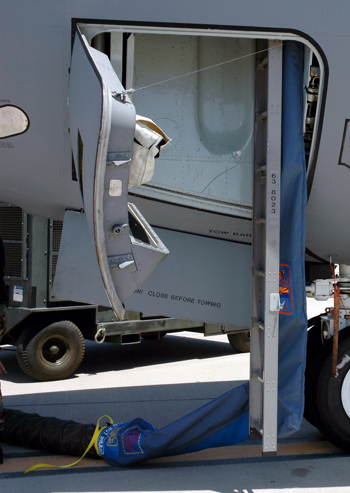 A fabricated cooling sock is attached behind the crew entry ladder of a KC-135 Stratotanker to allow cooling air onto the flight deck when the tanker is parked on a ramp in a very hot climate.  The cooling sock demonstrated an Air Mobility Battlelab KC-135 Hot Weather Cooling Sock initiative.  The use of the cooling sock has been recommended for fielding to Air Mobility Command officials by the battlelab staff, which is located at the U.S. Air Force Expeditionary Center on Fort Dix, N.J. (U.S. Air Force photo)