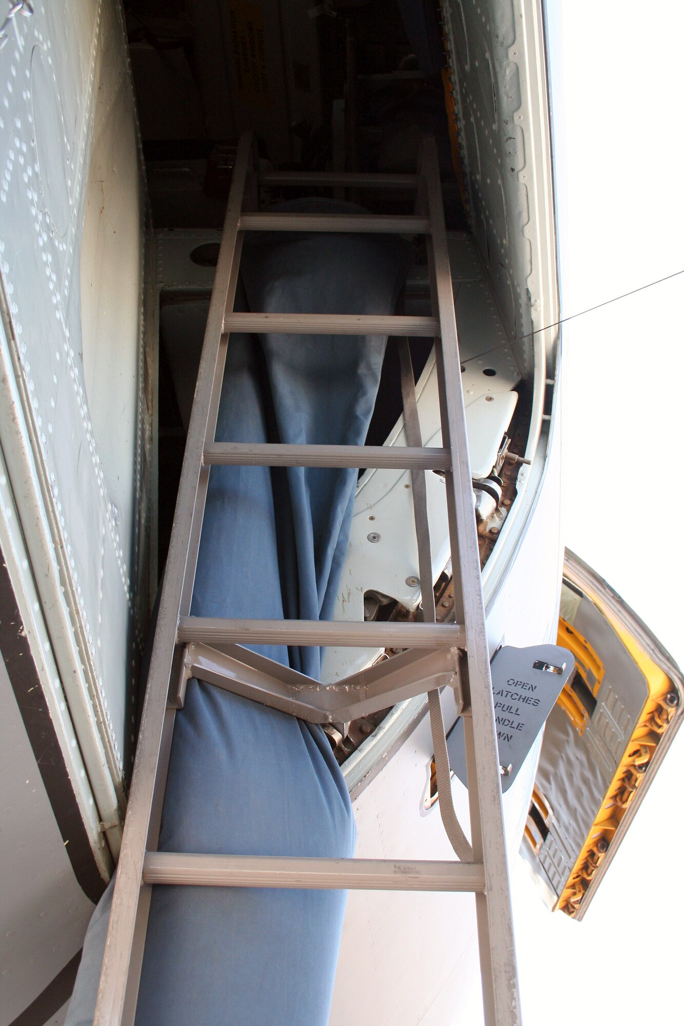 A fabricated cooling sock is attached behind the crew entry ladder of a KC-135 Stratotanker to allow cooling air onto the flight deck when the tanker is parked on a ramp in a very hot climate.  The cooling sock demonstrated an Air Mobility Battlelab KC-135 Hot Weather Cooling Sock initiative.  The use of the cooling sock has been recommended for fielding to Air Mobility Command officials by the battlelab staff, which is located at the U.S. Air Force Expeditionary Center on Fort Dix, N.J. (U.S. Air Force photo)