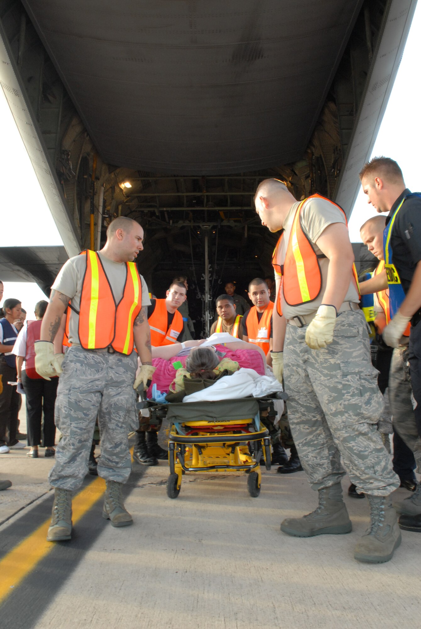 LACKLAND AIR FORCE BASE, Texas -- U.S. Air Force Airmen from the 37th and 59th Air Wing unload hospital patients that were evacuated from Beaumont, Texas, September 12, 2008. These patients were transported by a combined effort from the Little Rock Air Force Base C-130 aircraft and crews and the 908th Aero medical Evacuation Squadron, Scott Air Force Base, IL in preparation for Hurricane Ike's landfall in southern Texas.  (U.S. Air Force photo by Staff Sgt. Chris Willis) (RELEASED)
