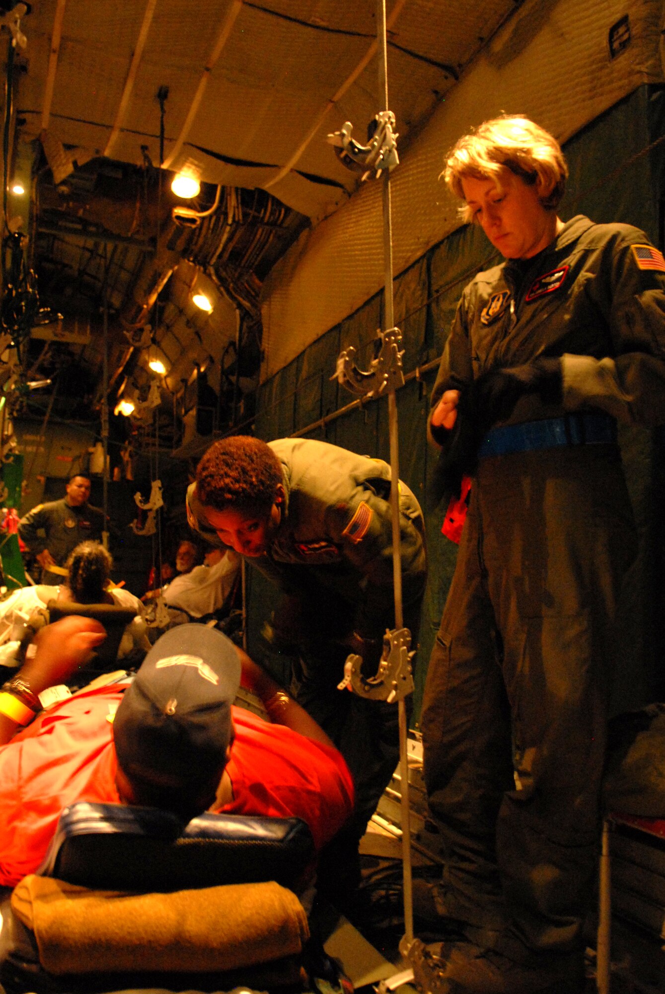 BEAUMONT AIRPORT, Texas -- Maj. Traci Shamburger and Senior Airman Melinda Ford prepare medical patients for their flight from Beaumont Airport, Texas to Lackland Air Force Base, Texas, September 12, 2008. These patients are being transported by a combined effort from the 61st Air Wing, C-130 aircraft and crews Little Rock Air Force Base and the 908th Aero medical Evacuation Squadron Scott Air Force Base, IL in preparation for Hurricane Ike's landfall in southern Texas.  (U.S. Air Force photo by Staff Sgt. Chris Willis) (RELEASED)