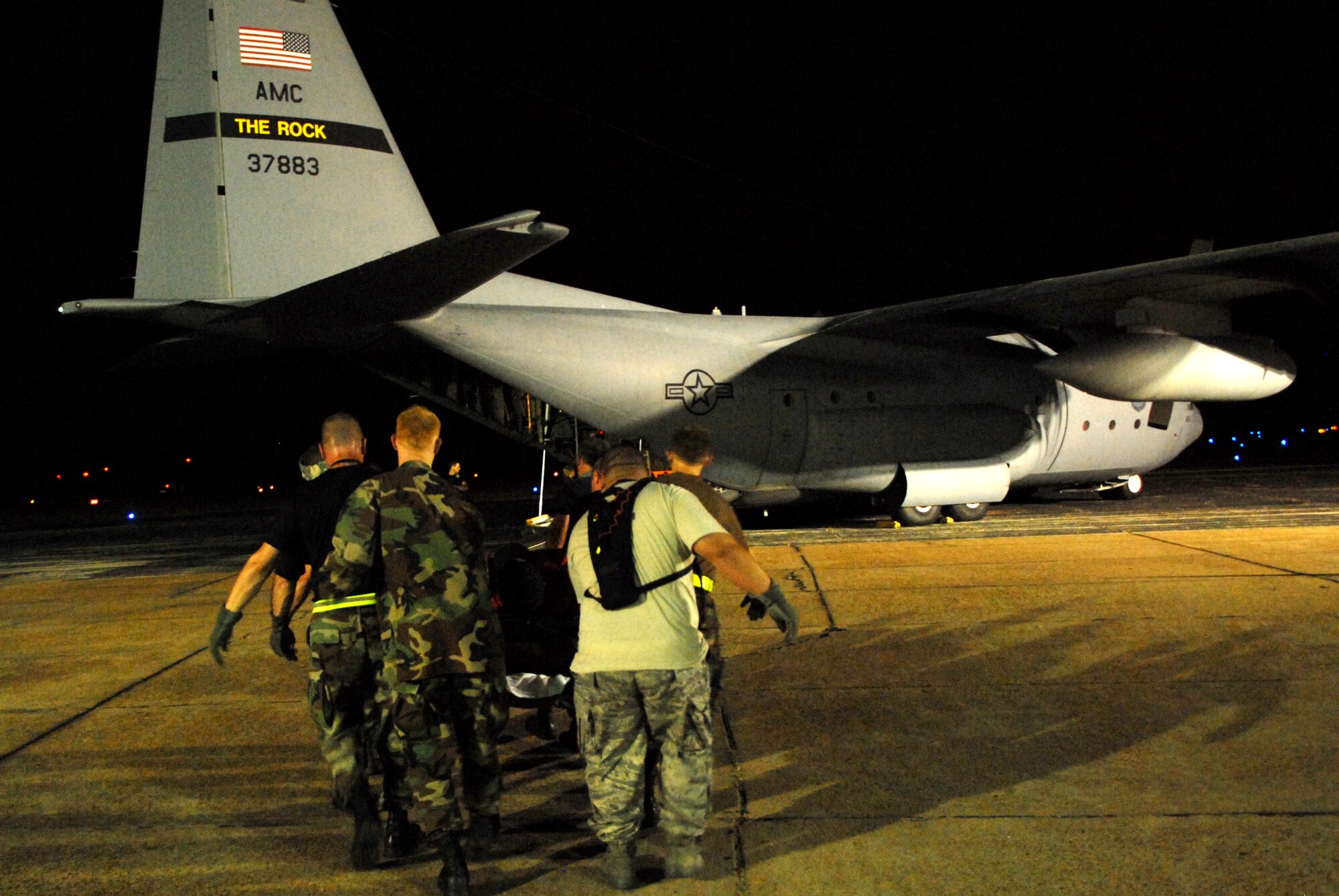 BEAUMONT AIRPORT, Texas -- U.S. Air Force Airmen made up of active duty, Guard, and Reserve from multiple Air Force Bases load hospital patients onto a C-130 aircraft, September 12, 2008. Little Rock Air Force Base C-130s were deployed to perform aero medical and transportation missions in preparation for Hurricane Ike's landfall in southern Texas.  (U.S. Air Force photo by Staff Sgt. Chris Willis) (RELEASED)