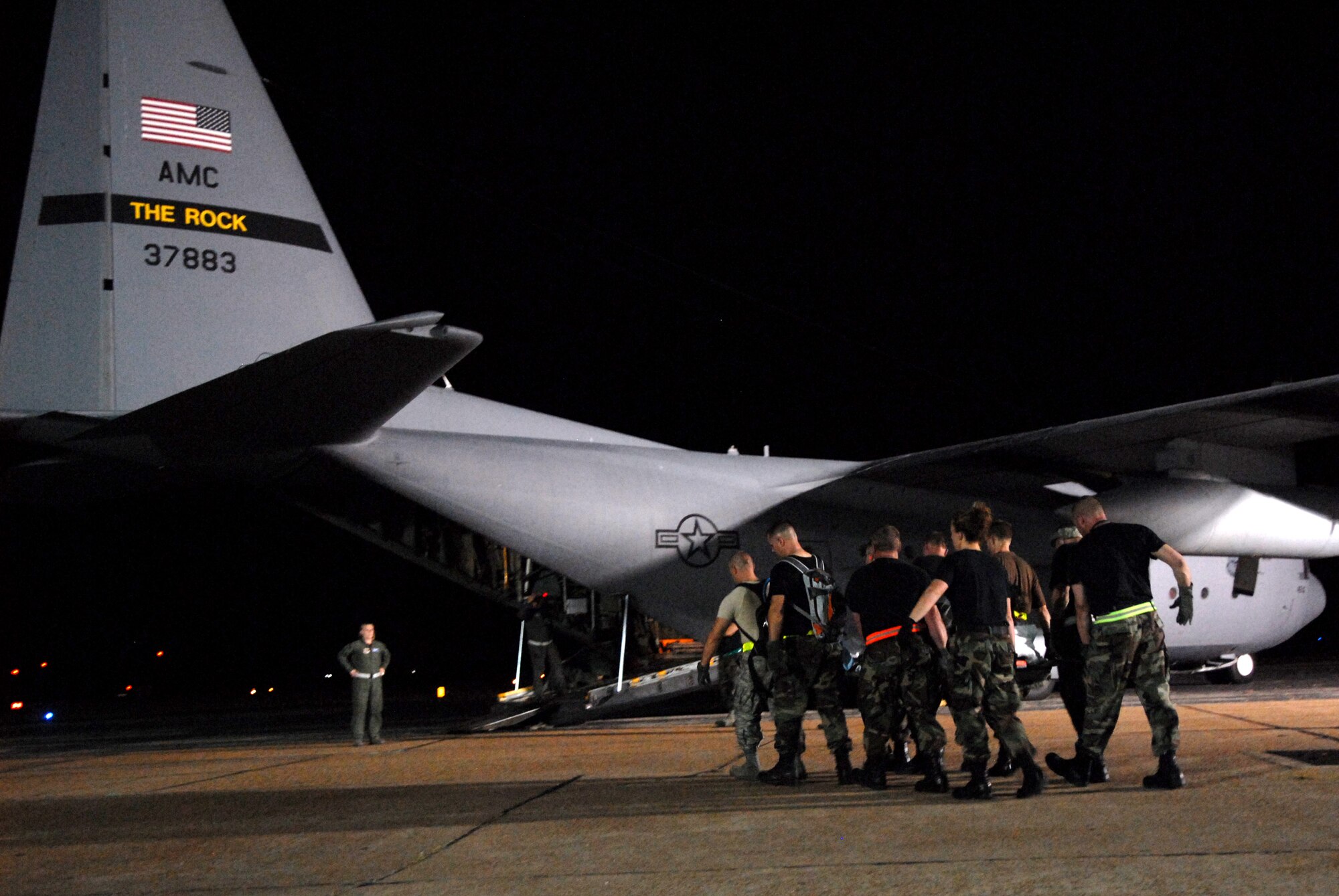 BEAUMONT AIRPORT, Texas -- U.S. Air Force Airmen made up of active duty, Guard, and Reserve from multiple Air Force Bases load hospital patients onto a C-130 aircraft, September 12, 2008. Little Rock Air Force Base C-130s were deployed to perform aero medical and transportation missions in preparation for Hurricane Ike's landfall in southern Texas.  (U.S. Air Force photo by Staff Sgt. Chris Willis) (RELEASED)