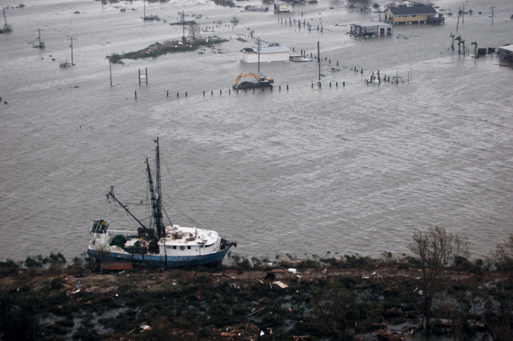 Airmen aboard an HH-60G Pave Hawk survey the damage caused by Hurricane Ike Sept. 13 around Galveston, Texas. Airmen from across the Air Force are deployed to the 331st Air Expeditionary Group at Randolph Air Force Base, Texas, to assist with rescue operations. (U.S. Air Force photo/Staff Sgt. Corey Parrish)
