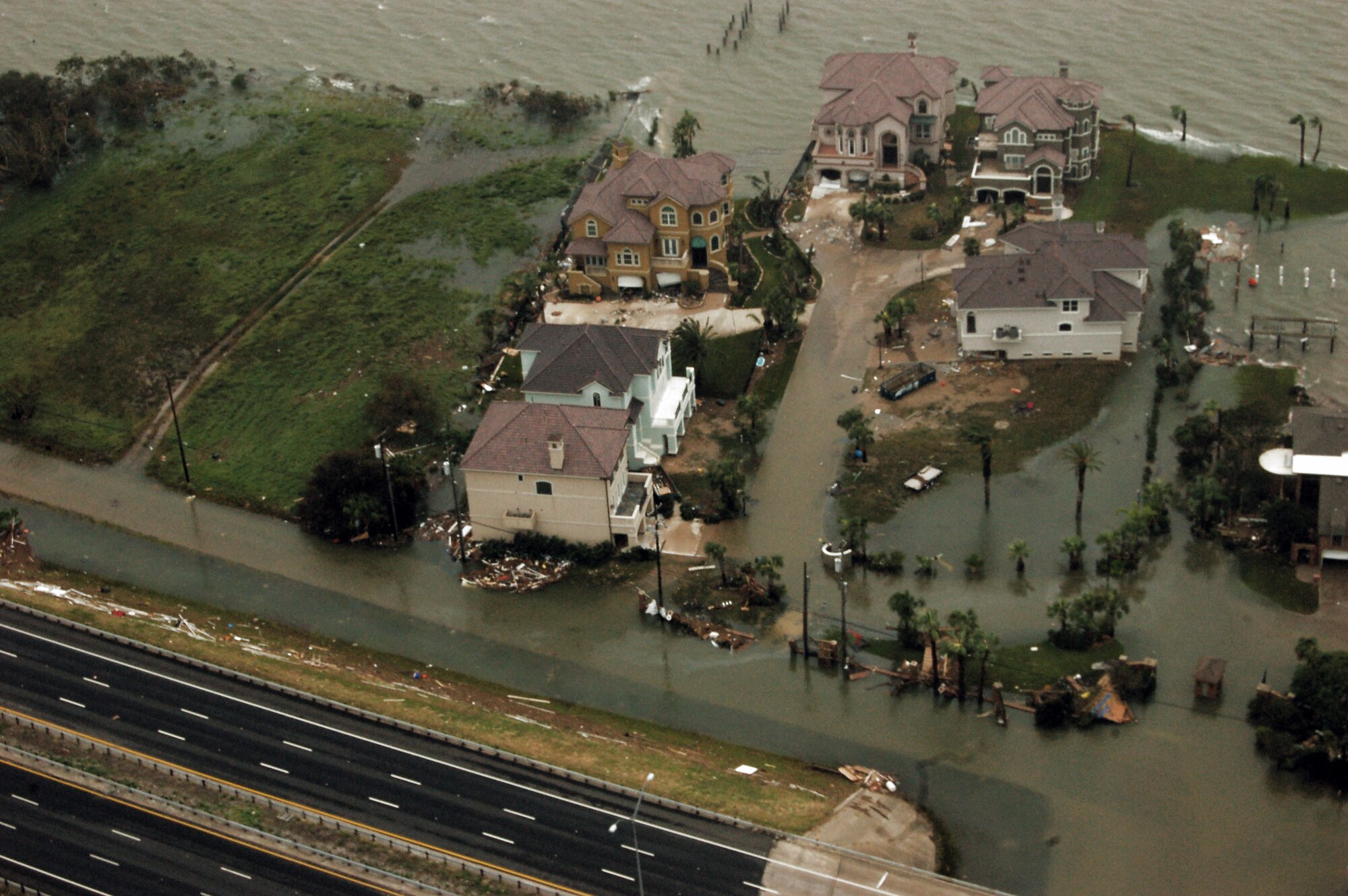 Airmen aboard an HH-60G Pave Hawk survey the damage caused by Hurricane Ike Sept. 13 around Galveston, Texas. Airmen from across the Air Force are deployed to the 331st Air Expeditionary Group at Randolph Air Force Base, Texas, to assist with rescue missions. Three HH-60Gs and two HC-130 Hercules aircraft from the 331st AEG flew over the devastated area to assist with relief operations. (U.S. Air Force photo/Staff Sgt. Corey Parrish) 
