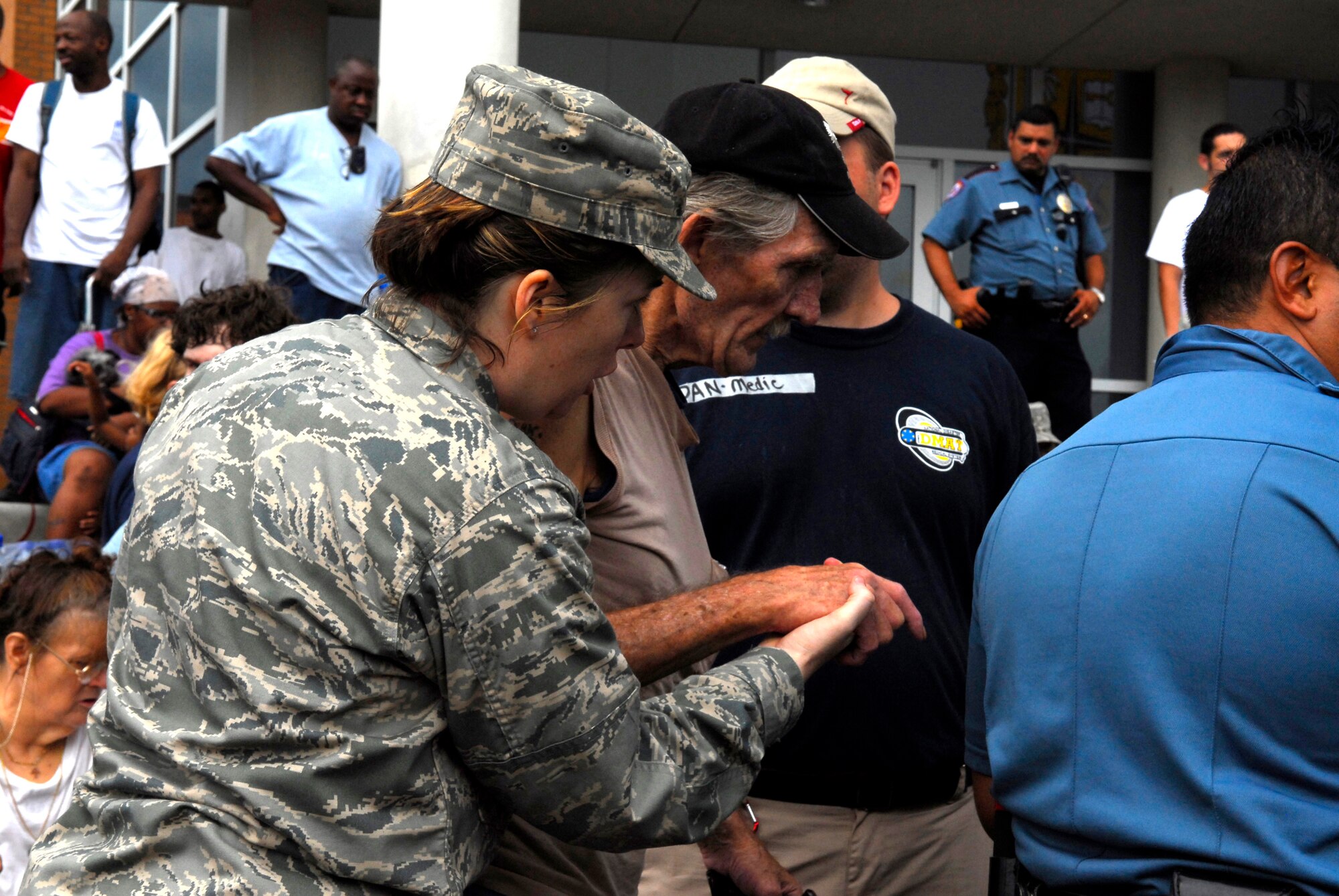 Capt. Shelly Garceau a nurse with the 149th Fighter Wing, Texas Air National Guard assists a resident evacuating Gavleston at Ball High School after hurricane Ike slammed into the Texas Coast.  Texas Military Forces personnel are part of the state and federal multi-agency Task Force Ike assisting in recovery af the category two hurricane. (Photo by Senior Master Sgt. Miguel Arellano)