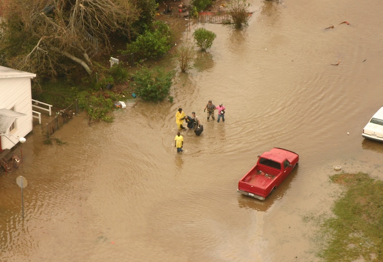 Joint Task Force 129 pararescuemen on board an HH-60G Pave Hawk help hurricane victims wade through the water to safety Sept. 13 in Galveston, Texas. The JTF 129 crews rescued 48 people and pets stranded in the Galveston area. (U.S. Air Force photo/Tech. Sgt. Brock Woodward)