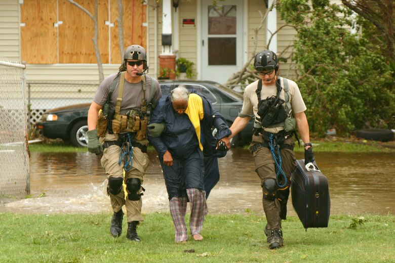 Joint Task Force 129 pararescuemen rescue a hurricane victim Sept. 13 in Galveston, Texas. The JTF 129 crews rescued 48 peoole and pets stranded in the Galveston area. (U.S. Air Force photo/Tech. Sgt. Brock Woodward) 