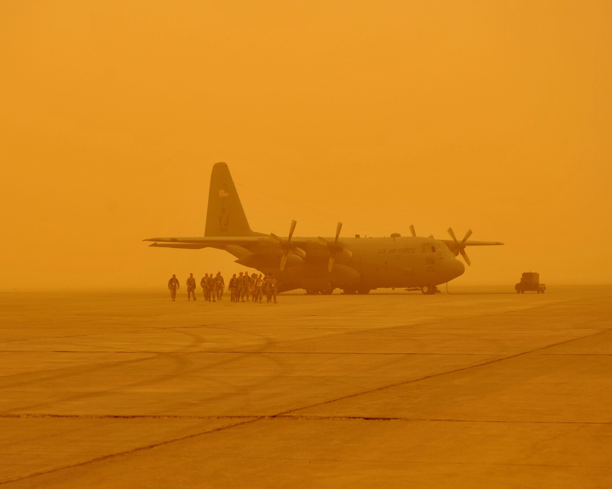 9/14/2008 ? SATHER AIR BASE, Iraq ? Passengers head back to the terminal to wait for  a dust storm to lift at Sather Air Base, on the west side of Baghdad International Airport. Aircraft were grounded throughout the day as the dust brought visibility down to less than 1,000 meters. The passengers were brought to the aircraft in hopes that visibility would improve, however conditions deteriorated and stopped air travel around the Baghdad area. (U.S. Air Force photo by Master Sgt. Brian Davidson)