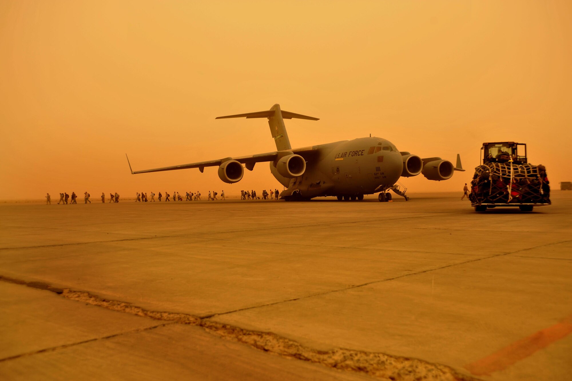 9/14/2008 ? SATHER AIR BASE, Iraq ? Passengers deplane a C-17 Globemaster III aircraft at Sather Air Base on the west side of Baghdad International Airport after a dust storm brought visibility down to less than 1,000 meters. The C-17 was able to take off before conditions deteriorated and stopped air travel around the Baghdad area, but the passengers were left waiting for the storm to lift and air travel to resume so they could continue on to their destinations. (U.S. Air Force photo by Master Sgt. Brian Davidson)