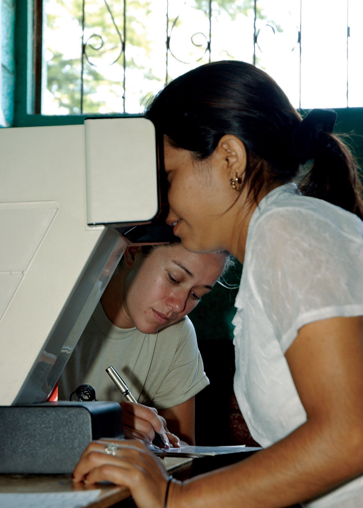 Tech. Sgt. Shirley Morales takes notes during a vision screening at a school in Santa Rosa, Guatemala.  Sergeant Morales, who was born and raised in Santa Rosa, accompanied the 163d Medical Group during a recent medical readiness training exercise to assist with translating for the team.  Sergeant Morales is a force development technician with the 163rd Reconnaissance Wing.  (U.S. Air Force photo)