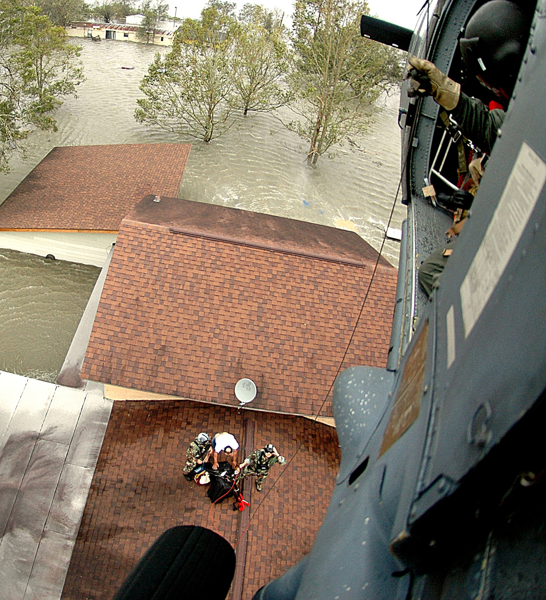 NEDERLAND, Texas -- An Air Force Reserve aircrew from the 920th Rescue Wing prepares to rescue a family trapped on their roof by flood waters from Hurricane Ike. Deployed from their home at Patrick AFB, Fla. along with two HH-60G Pave Hawk helicopters and two HC-130P/N refueling aircraft, the Reserve Airmen saved 17 people from the tiny Texas town (population 2,000) Sept. 13. (U.S. Air Force photo/Tech. Sgt. Paul Flipse)