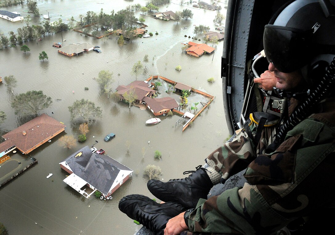 RANDOLPH AIR FORCE BASE, Texas -- An Air Force Reserve pararescueman assigned the 331st Air Expeditionary Group here scans the ravaged Texas landscape for signs of life in the aftermath of Hurricane Ike. Deployed from the 920th Rescue Wing at Patrick AFB, Fla., the pararescuemen, along with two aircrews, two HH-60G Pave Hawk helicopters and two HC-130P/N refueling aircraft, saved 17 people from the tiny Texas town of Nederland Sept. 13. (U.S. Air Force photo/Tech. Sgt. Paul Flipse)