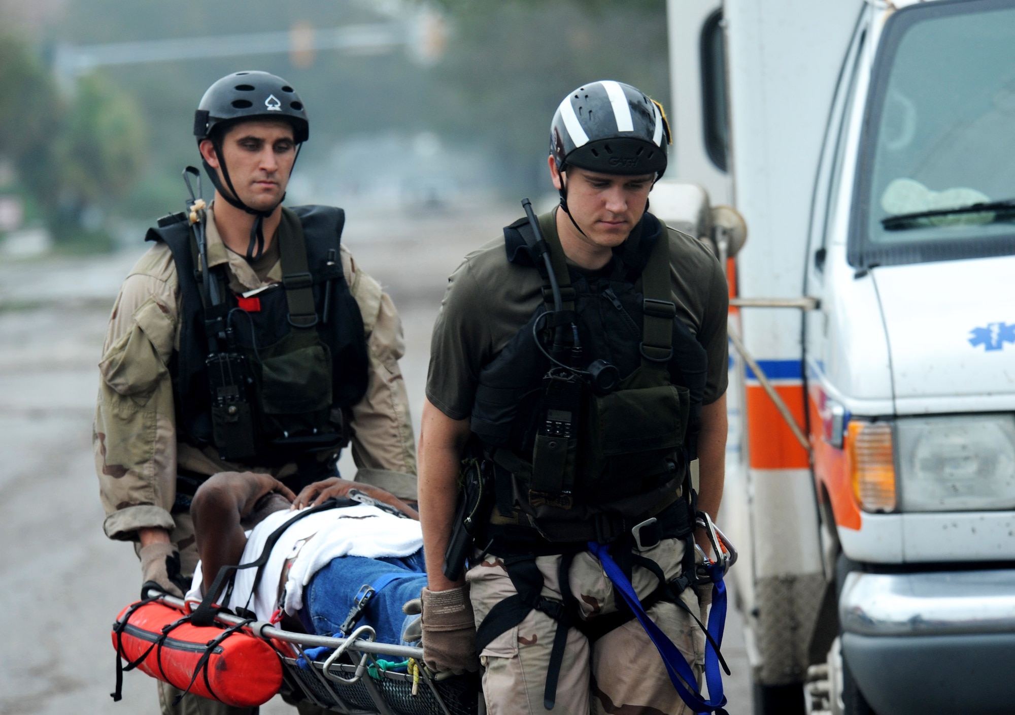 Staff Sgt. Lopaka Mounts (left) and Senior Airman Brandon Smith,cross-load an injured Galveston, Texas, resident from an ambulance for air evacuation during search and rescue operations after Hurricane Ike, Sept. 13. Sergeant Mounts and Airman Smith are both pararescueman assigned to the 331st Air Expeditionary Group at Randolph Air Force Base, Texas. (U.S. Air Force photo/Staff Sgt. James L. Harper Jr.)
