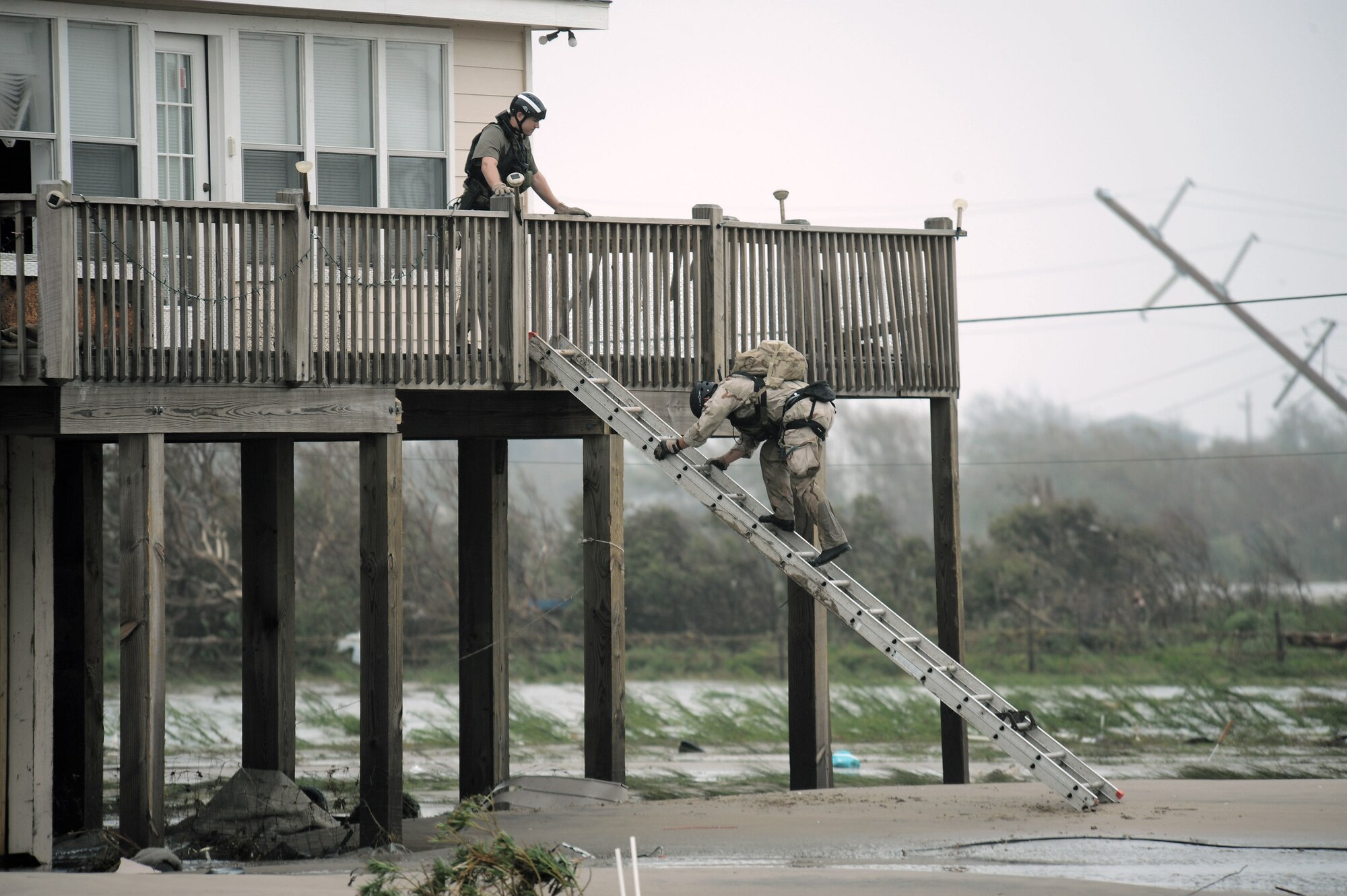 Senior Airman Brandon Smith (left) and Staff Sgt. Lopaka Mounts conduct search and rescue operations in Galveston, Texas, after Hurricane Ike, Sept. 13. Sergeant Mounts and Airman Smith are both pararescueman assigned to the 331st Air Expeditionary Group at Randolph Air Force Base, Texas. (U.S. Air Force photo/Staff Sgt. James L. Harper Jr.)