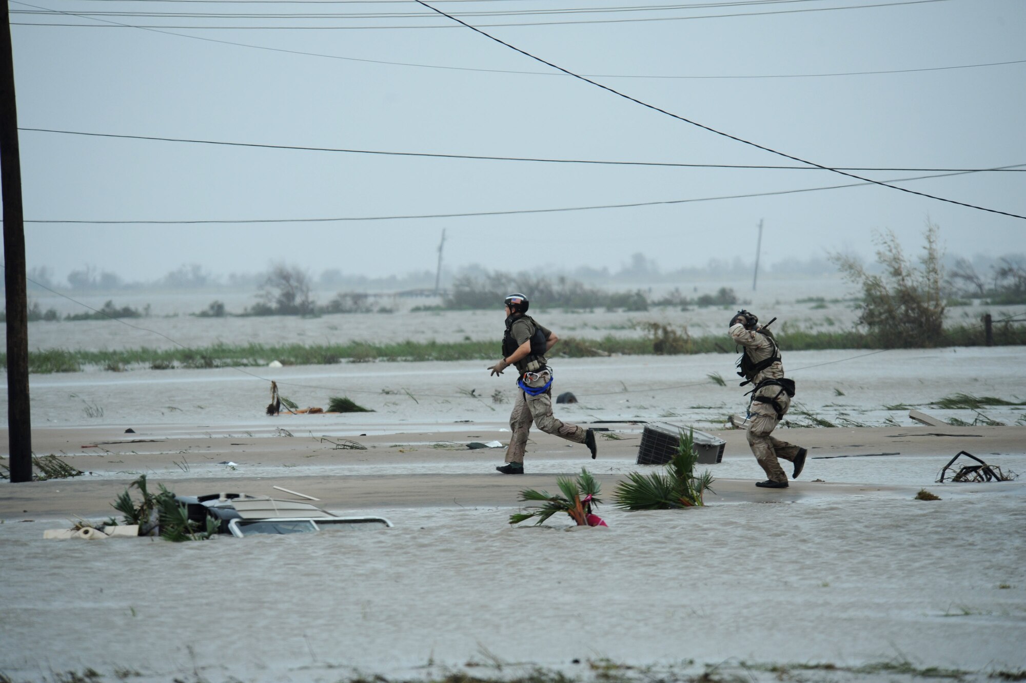 Senior Airman Brandon Smith (left) and Staff Sgt. Lopaka Mounts conduct search and rescue operations in Galveston, Texas, after Hurricane Ike, Sept. 13. Sergeant Mounts and Airman Smith are both pararescueman assigned to the 331st Air Expeditionary Group at Randolph Air Force Base, Texas. (U.S. Air Force photo/Staff Sgt. James L. Harper Jr.)