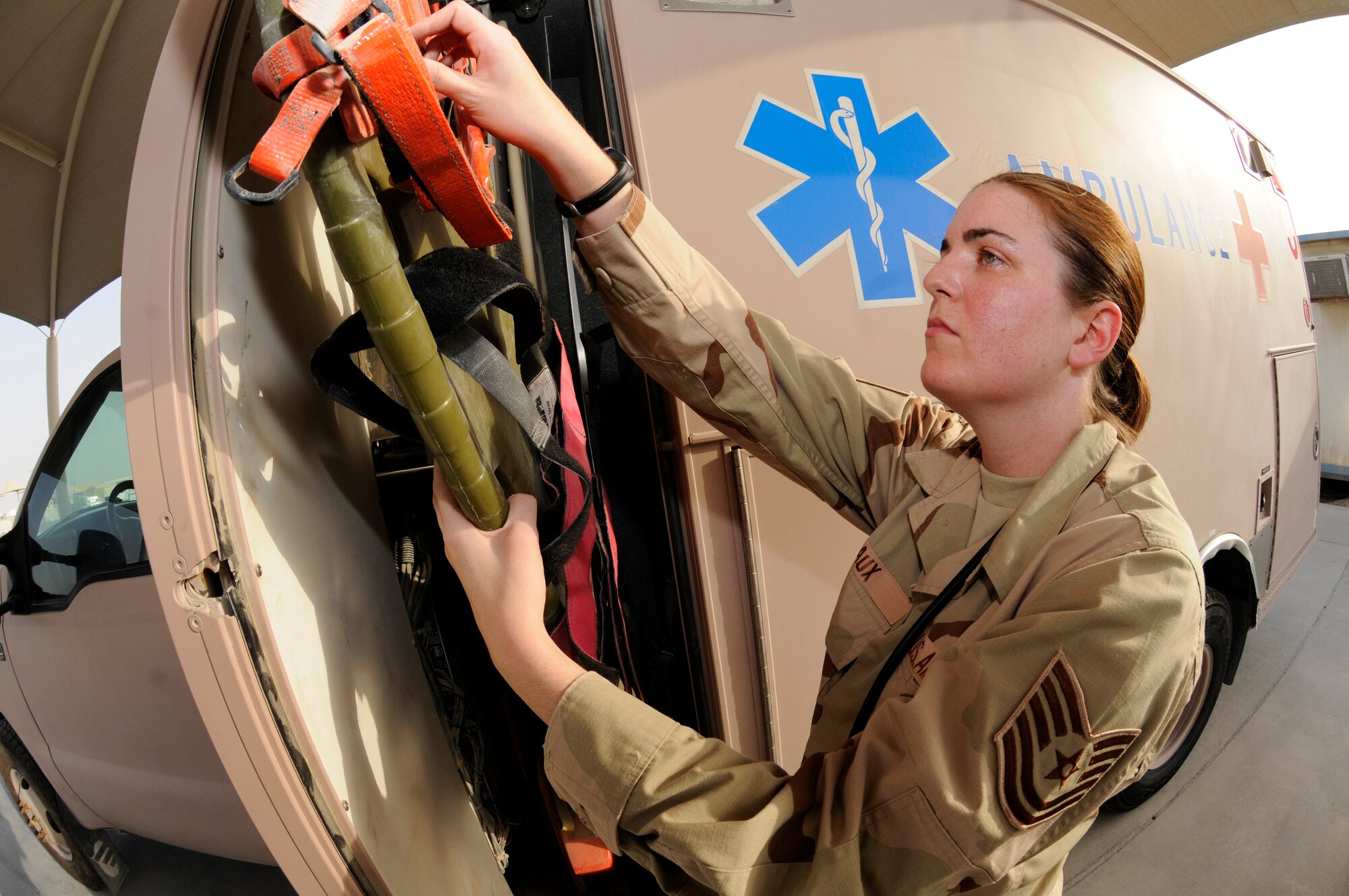 Tech. Sgt. Gina Laux, an independent duty medical technician assigned to the 379th Expeditionary Medical Group, attaches spider straps to a backboard in an ambulance Sept. 12, 2008, at an undisclosed air base in Southwest Asia. The backboard is used to load patients with spinal injuries onto the ambulance without causing further injuries. Sergeant Laux strives to keep deployed members healthy so they can continue the fight. Sergeant Laux, a native of Tampa, Fla., is deployed from Ellsworth Air Force Base, S.D., supporting Operations Iraqi Freedom, Enduring Freedom and Joint Task Force-Horn of Africa. (U.S. Air Force photo by Staff Sgt. Darnell T. Cannady/Released)