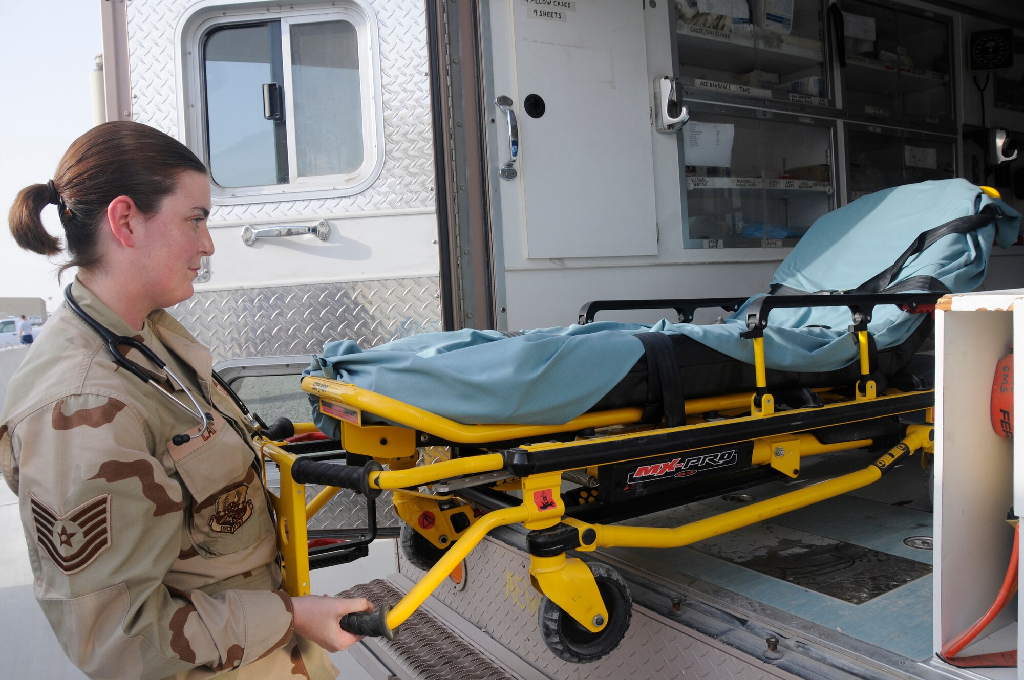 Tech. Sgt. Gina Laux, independent duty medical technician assigned to the 379th Expeditionary Medical Group, loads a stretcher into the back of an ambulance Sept. 12, 2008, at an undisclosed air base in Southwest Asia. Sergeant Laux strives to keep deployed members healthy so they can continue the fight. Sergeant Laux, a native of Tampa, Fla., is deployed from Ellsworth Air Force Base, S.D., supporting Operations Iraqi Freedom, Enduring Freedom and Joint Task Force-Horn of Africa. (U.S. Air Force photo by Staff Sgt. Darnell T. Cannady/Released)