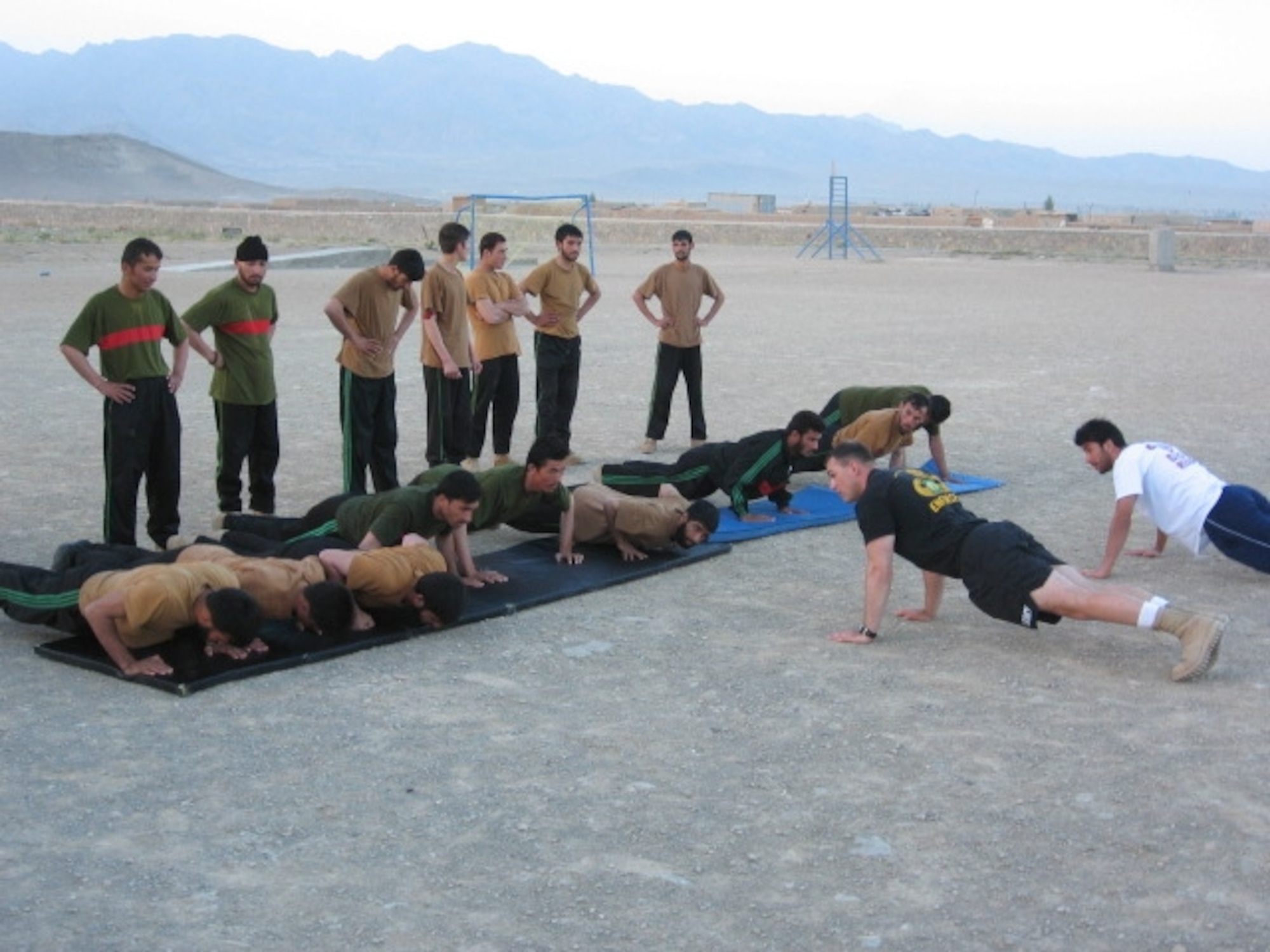 Sgt. 1st Class Steve Palazzo, a native of Charlotte, N.C., leads Afghan National Army Military Police Class 01-08 in an early morning physical training session. (U.S. Army photo by Capt. Mike Miranda)