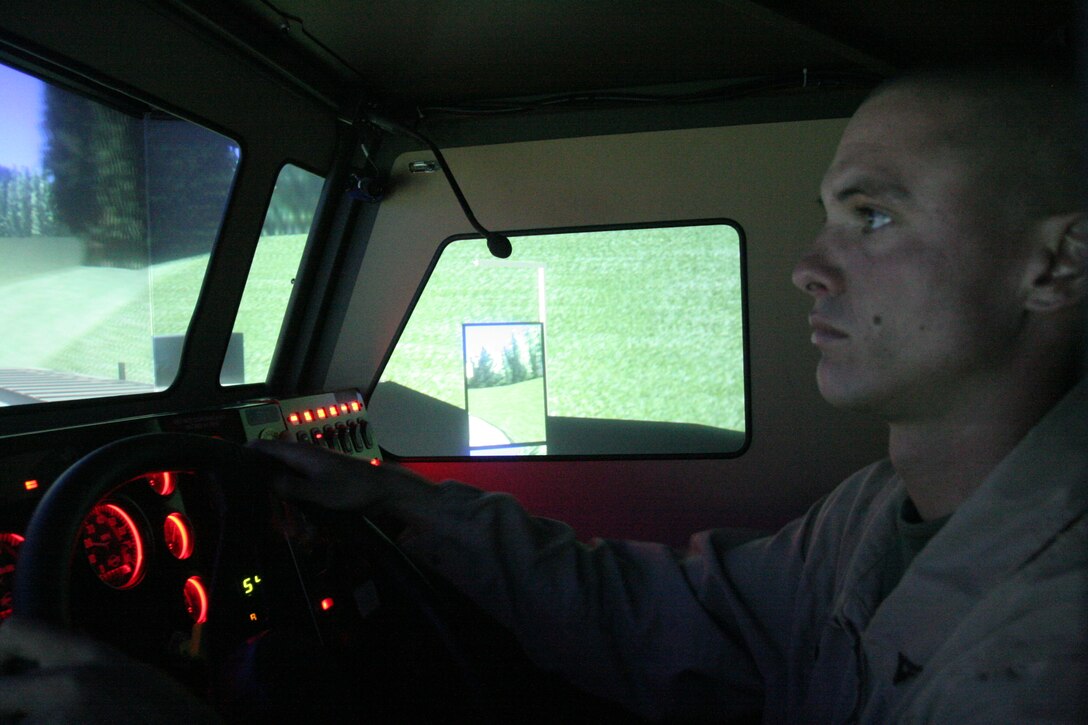 Lance Cpl. Richard D. Smith, a motor transportation operator with Headquarters and Service Company, 1st Tank Battalion, drives through one of the simulations in a virtual Mine Resistant Armor Protected vehicle Sept. 15.  Simulators for the Mine Resistant Ambush Protected vehicles, as well as humvees and 7-tons, are maintained at the Combat Center’s Battle Simulation Center to give Marines a feel for driving tactical vehicles without the huge expenditures in fuel, maintenance and repairs.