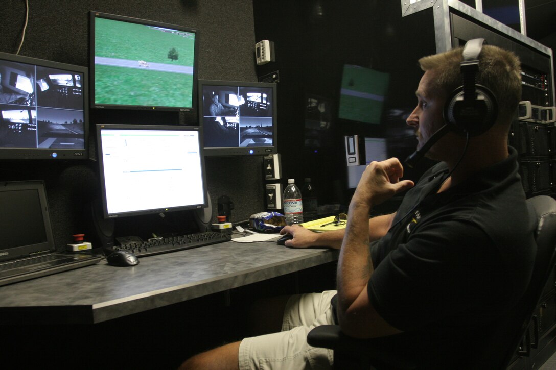 Douglas Peercy, the operator/maintainer of the Combat Center’s Battle Simulation Center guides two Marines from 1st Tank Battalion through one of the simulations while they operate a virtual Mine Resistant Armor Protected vehicle. Simulators for the Mine Resistant Ambush Protected vehicles, as well as humvees and 7-tons, are maintained at the Combat Center’s Battle Simulation Center to give Marines a feel for driving tactical vehicles without the huge expenditures in fuel, maintenance and repairs.