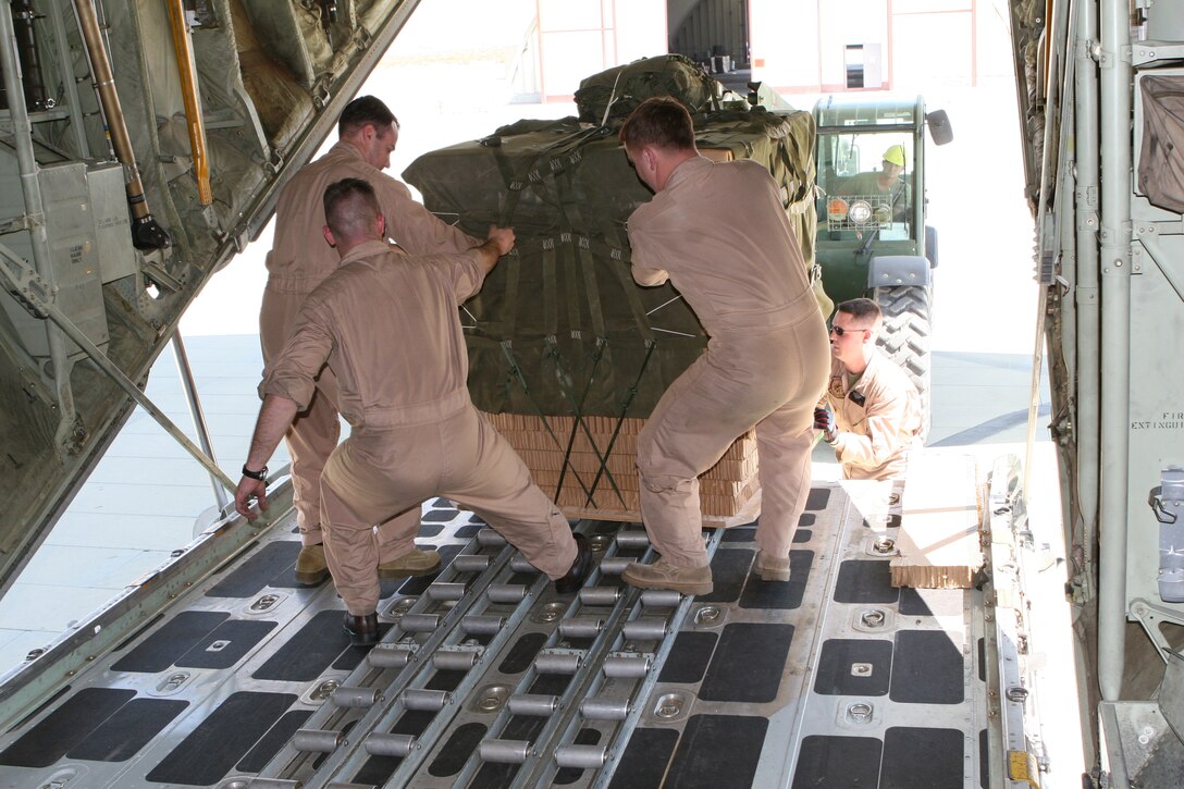 Marines of Marine Aerial Transport Squadron 234 pull a crate of Meals, Ready-to-Eat onto a KC-130T Hercules Aircraft in preparation of a re-supply operation supporting service members training in Mojave Viper Sept. 15.  The remain behind element of Marine Wing Support Squadron 374 also supported the Marines of VMGR-234 during the operation.