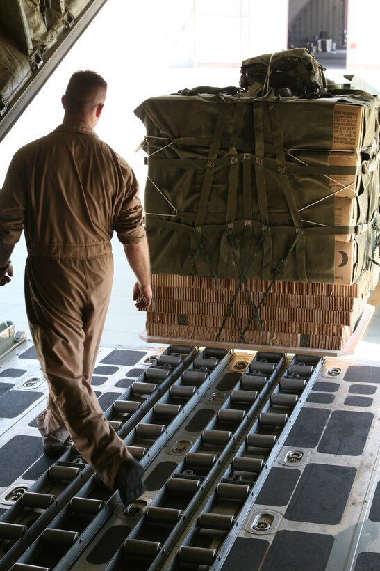 Lance Cpl. Anthony P. Kennedy, a load master student with Marine Aerial Transport Squadron 234, ensures a load of Meals, Ready-to-Eat is centered on the KC-130T Hercules Aircraft used to perform a re-supply operation in support of Mojave Viper Sept. 15.  The remain behind element of Marine Wing Support Squadron 374 also supported the Marines of VMGR-234 during the operation.
