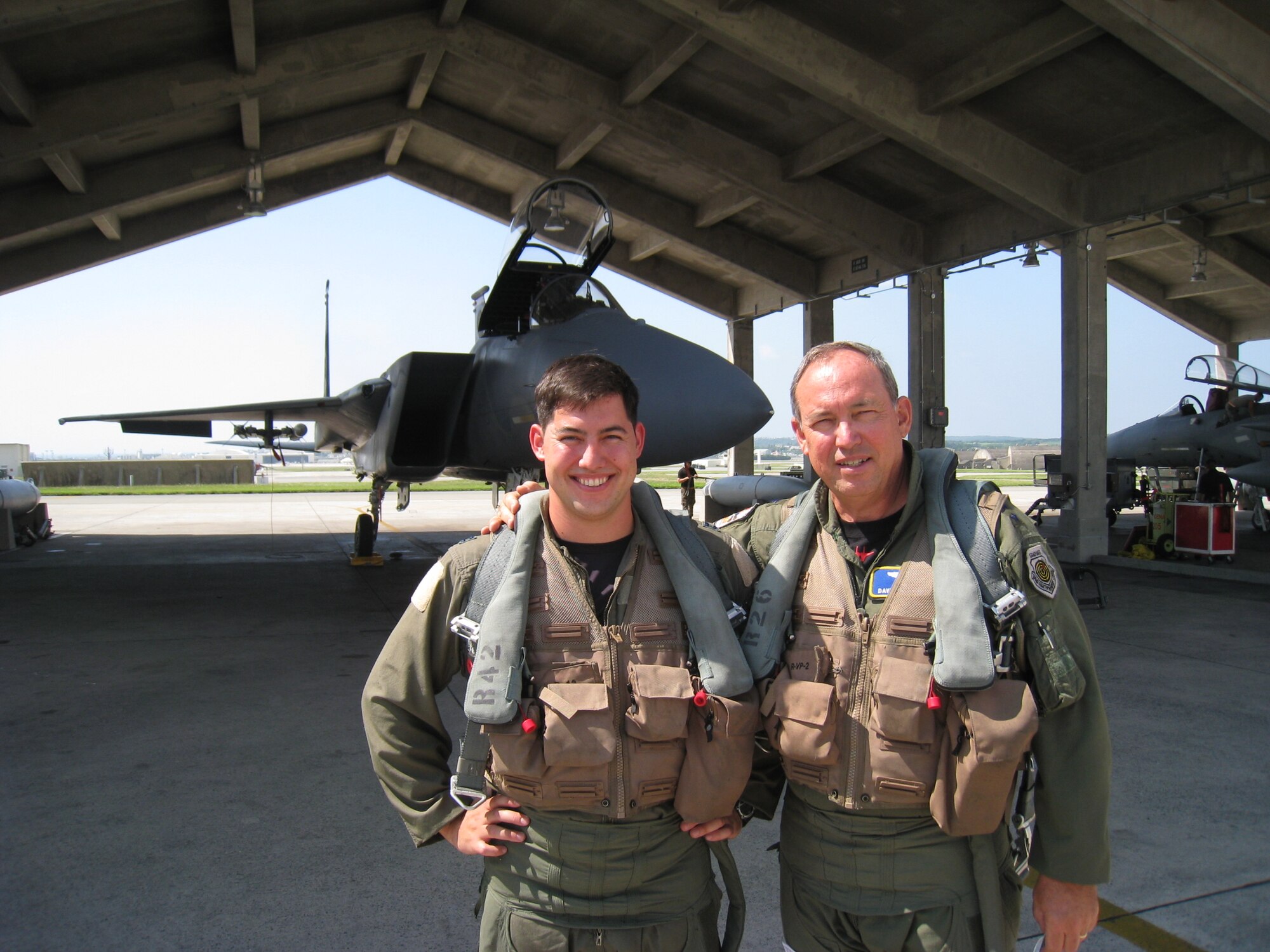 Captain David Deptula, an F-15 pilot with the 67th
Fighter Squadron and his father, Lt. Gen. David Deptula, Air Force Deputy
Chief of Staff for Intelligence, Surveillance and Reconnaissance, prepare
for an F-15 flight at Kadena Air Base, Japan, Sept. 4, 2008. General
Deptula, an F-15 pilot and a former member of the 67th Fighter Squadron
himself from 1979-1983, had the rare opportunity to fly with his son during
a trip to visit Air Force ISR professionals in the Pacific region. (Photo courtesy of U.S. Air Force) 
